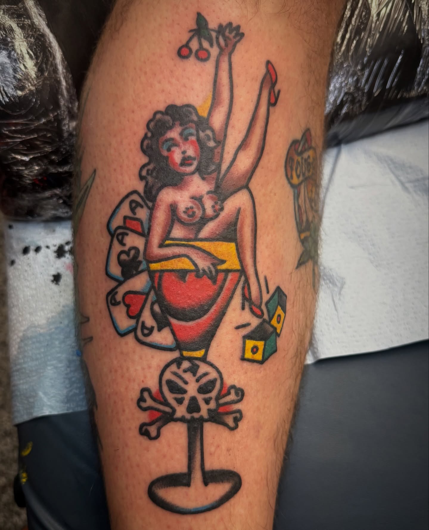 Pin-up girl with cherries American traditional tattoo on the thigh by Chuck Paprocki, Nashville, Tennessee