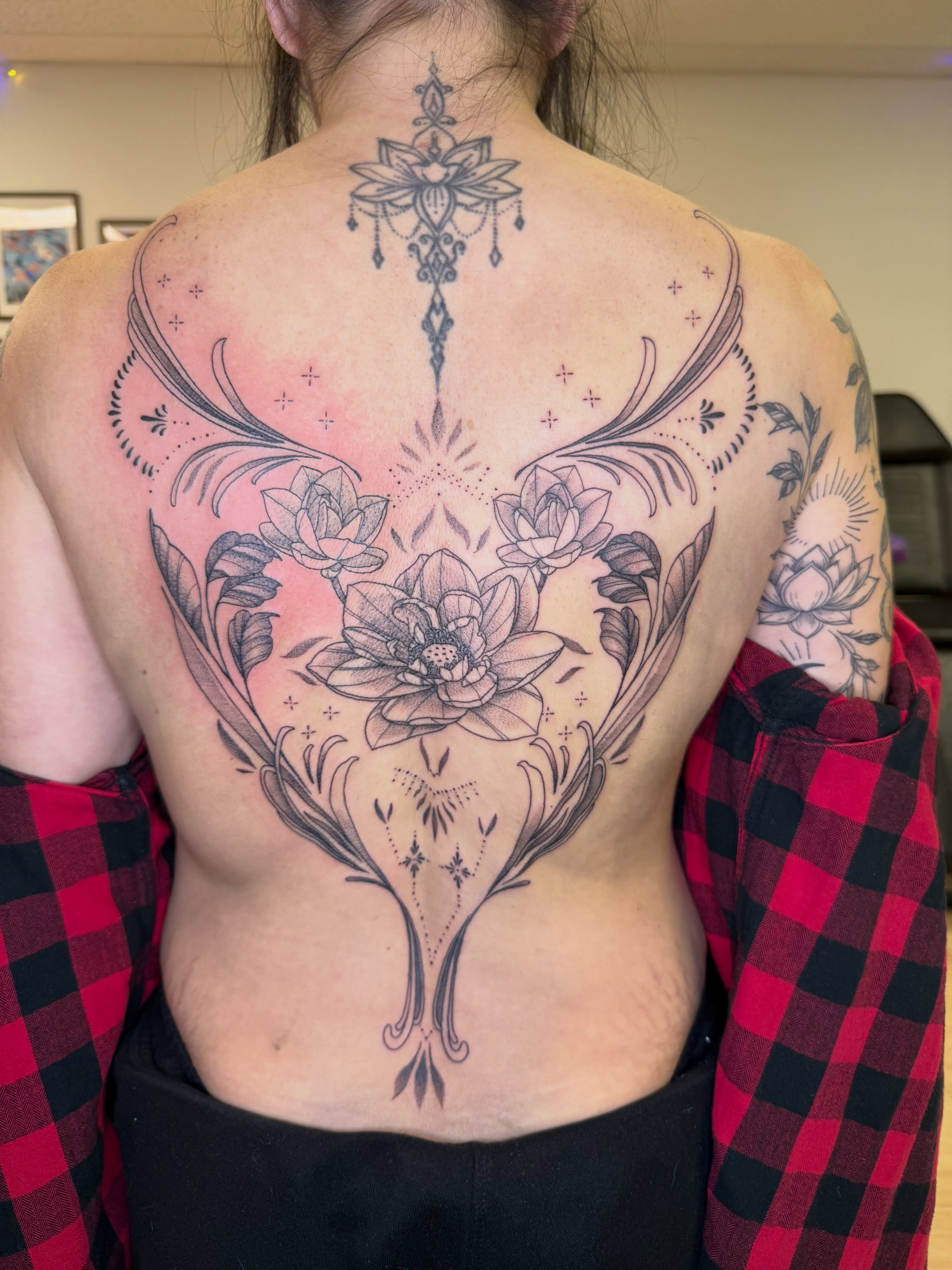 Lotus flowers geometric tattoo on the back by Stvn Geyer, Urbandale, Iowa