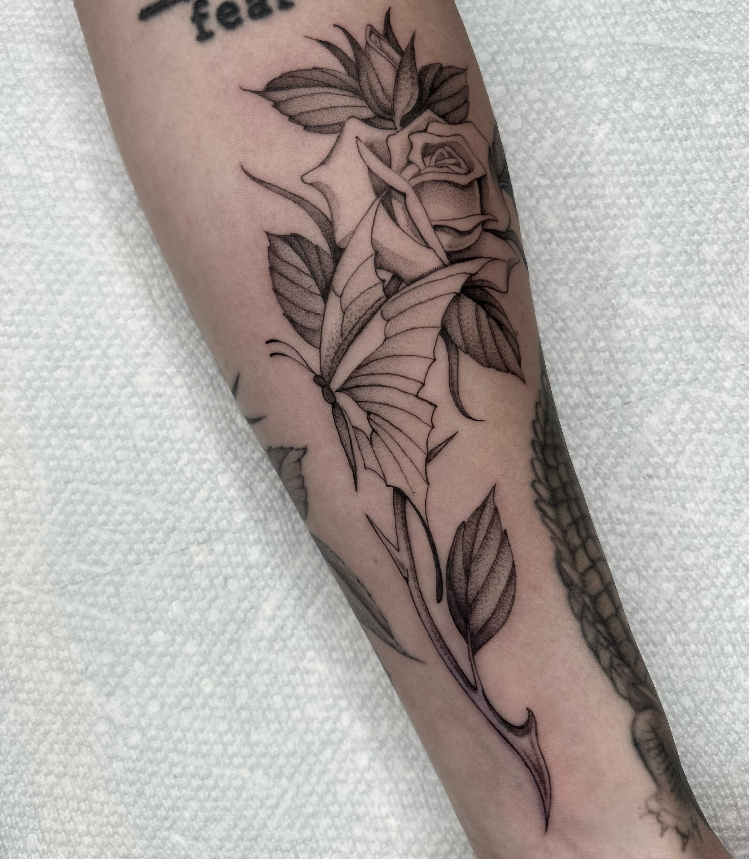 Rose black and grey tattoo on the forearm by Olivia Fox