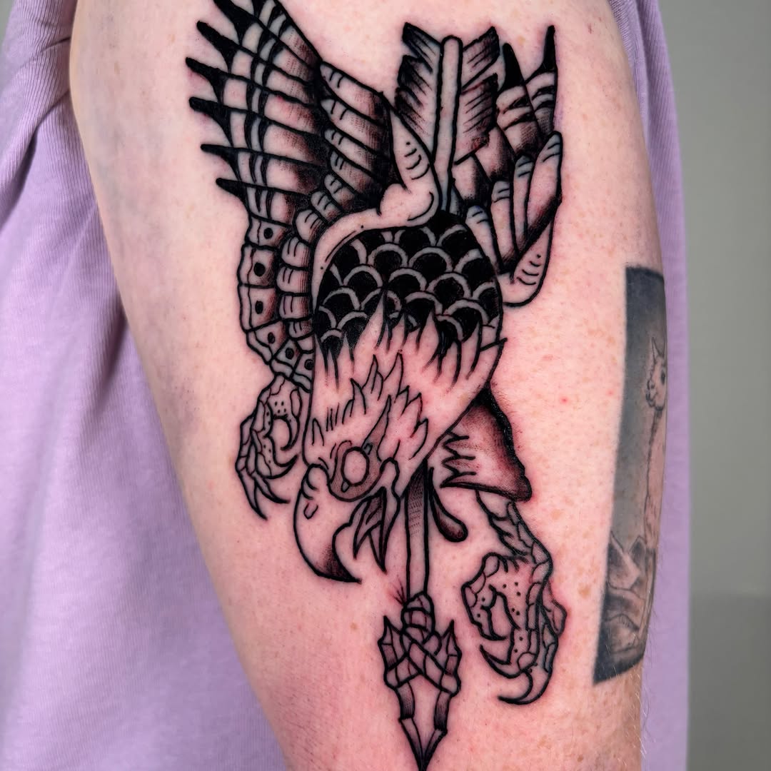 Heart with wings black and grey tattoo on the forearm by Davie Tattoos