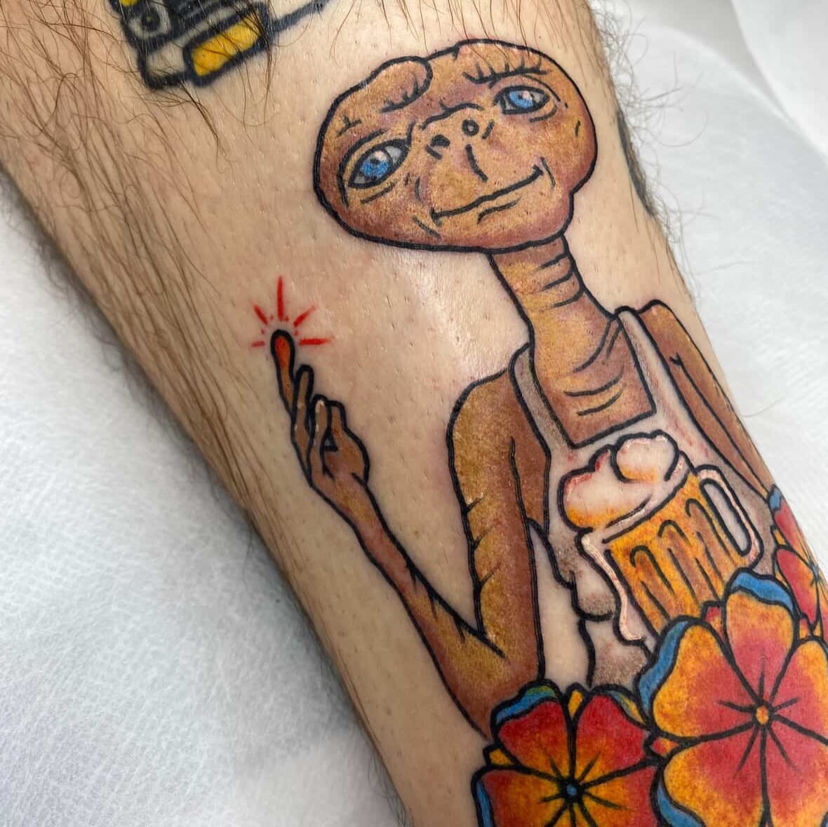 E.T illustrative tattoo on the forearm by Davie Tattoos