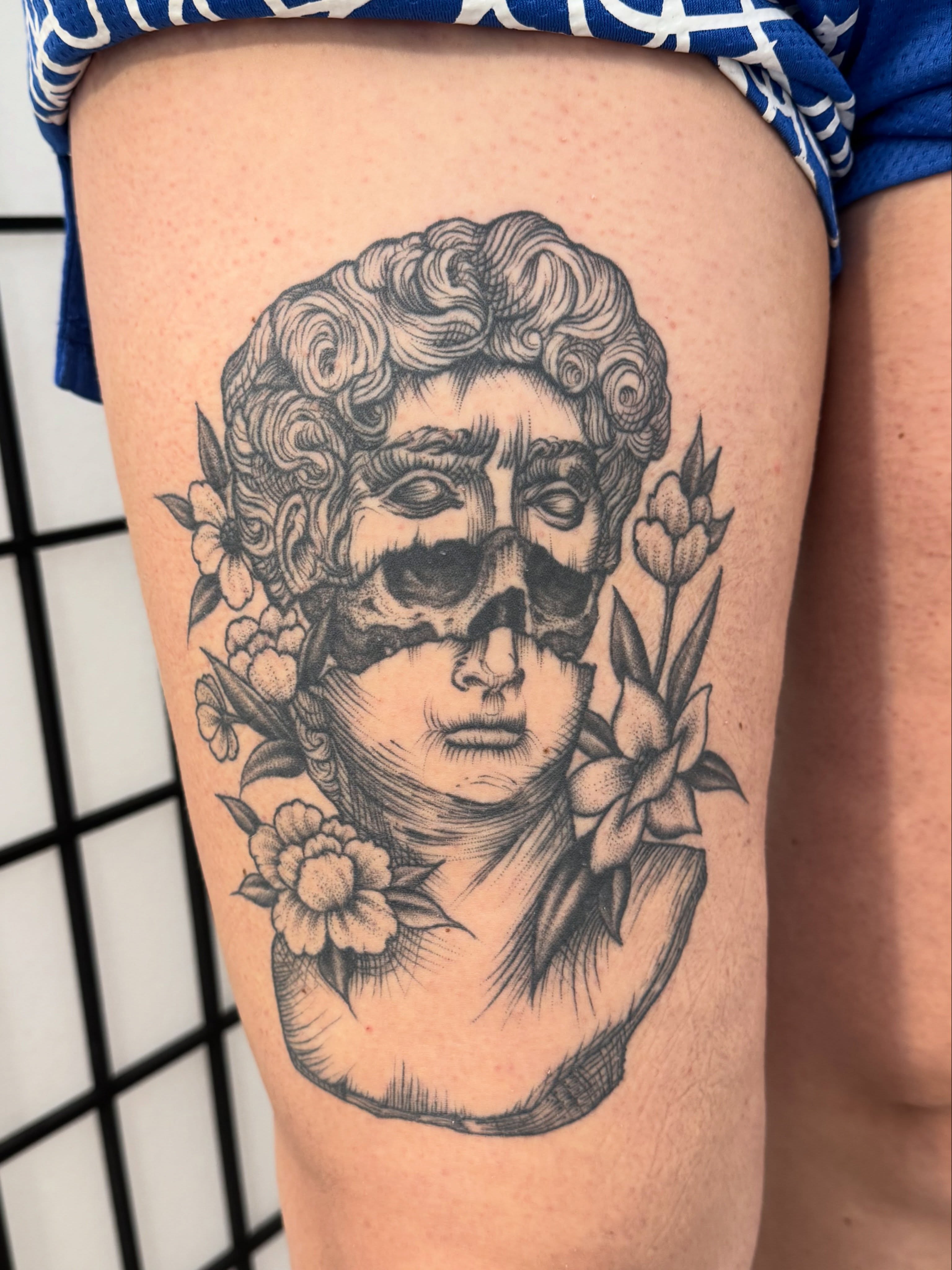 Skull and flowers realism tattoo on the thigh by JARED Boston Tattooer: Traditional, Fine, Boston, Massachusetts
