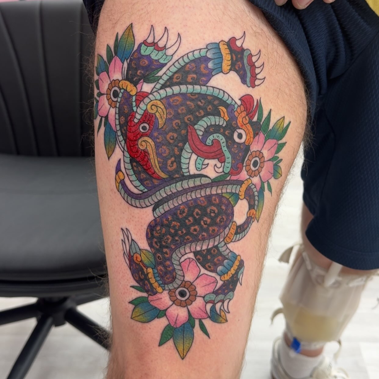 Serpent and flowers American traditional tattoo on the thigh by Lindsay