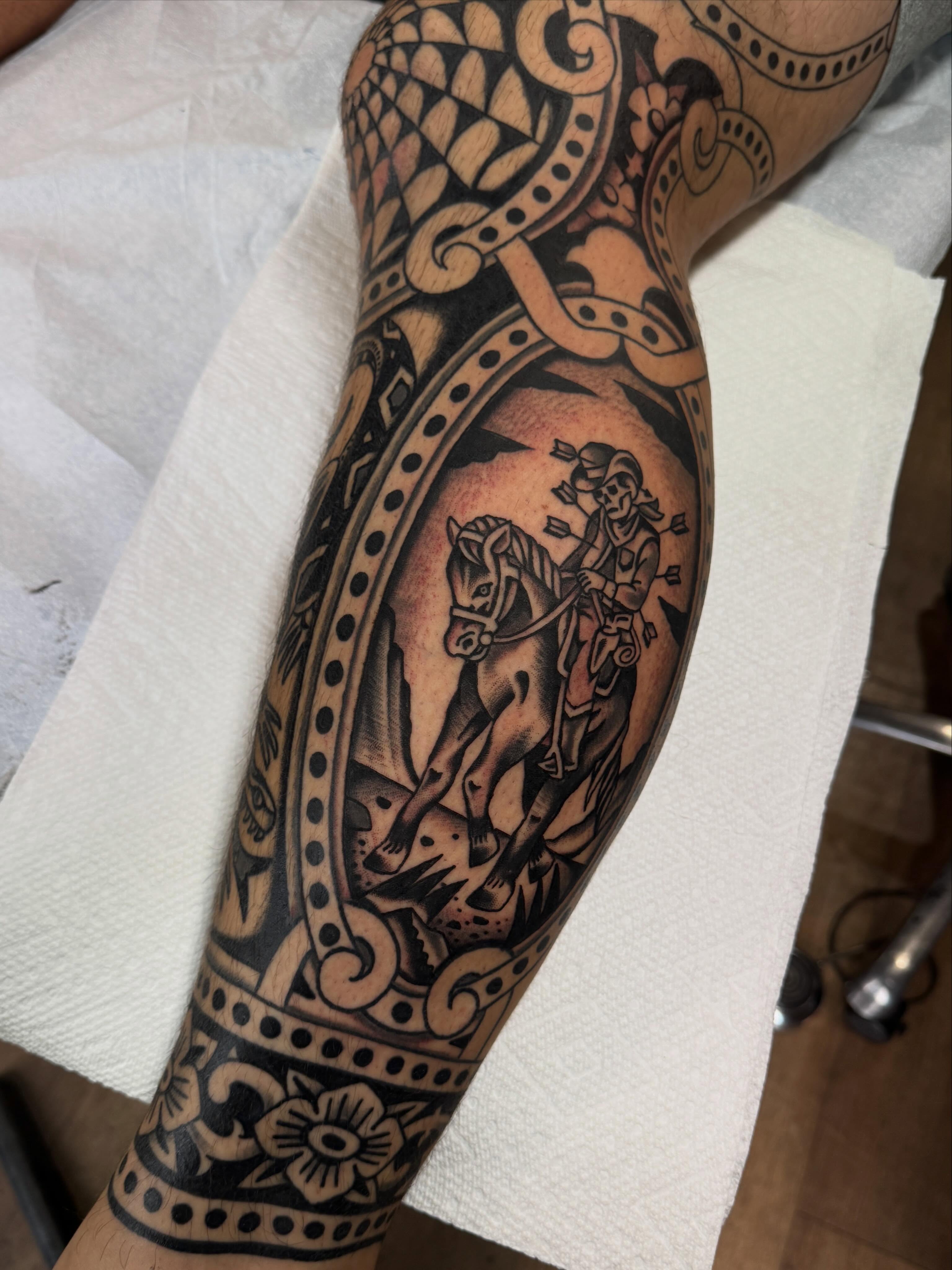 Horse and rider black and grey tattoo on the forearm by Ryan Engels