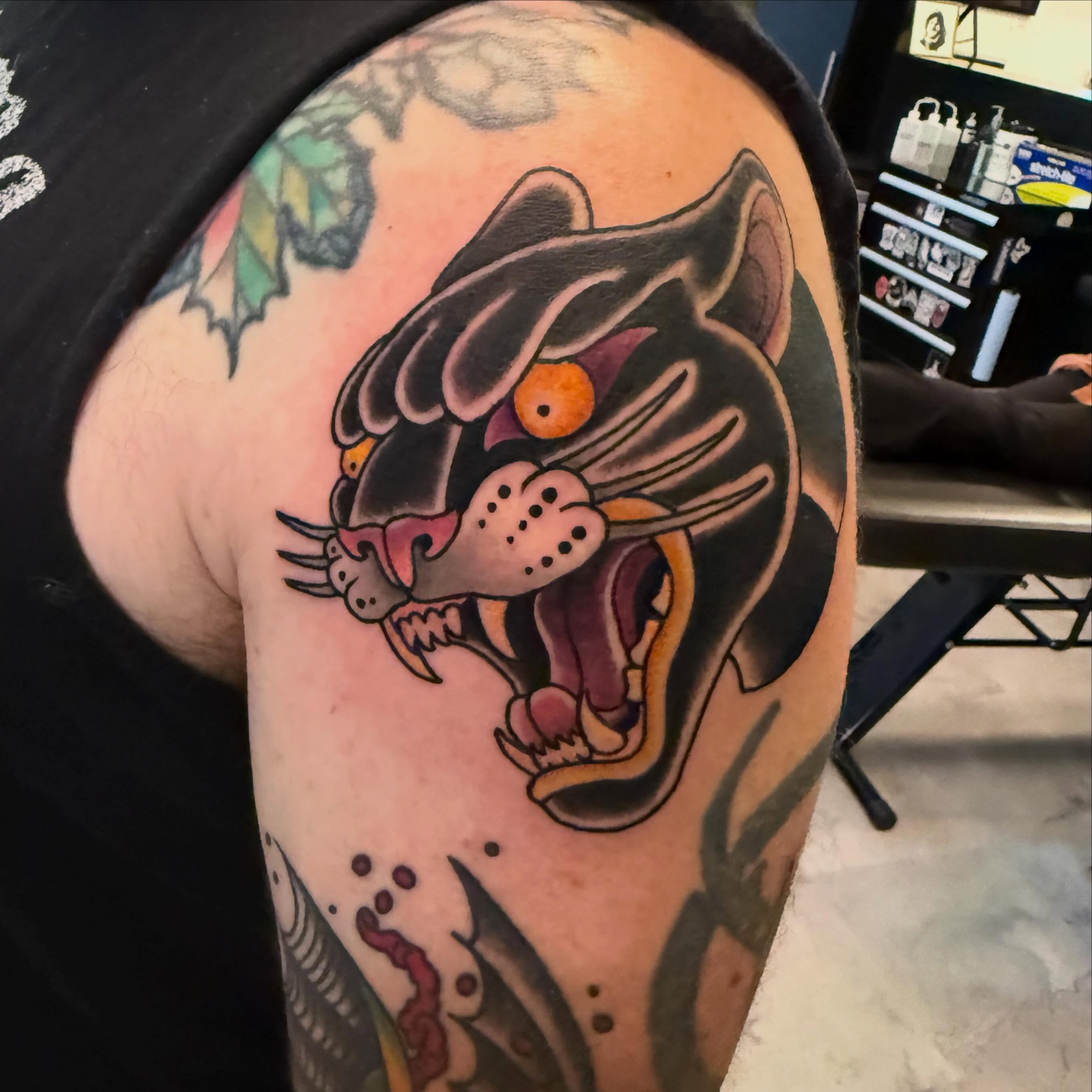 Panther American traditional tattoo on the shoulder by Kyle Behr