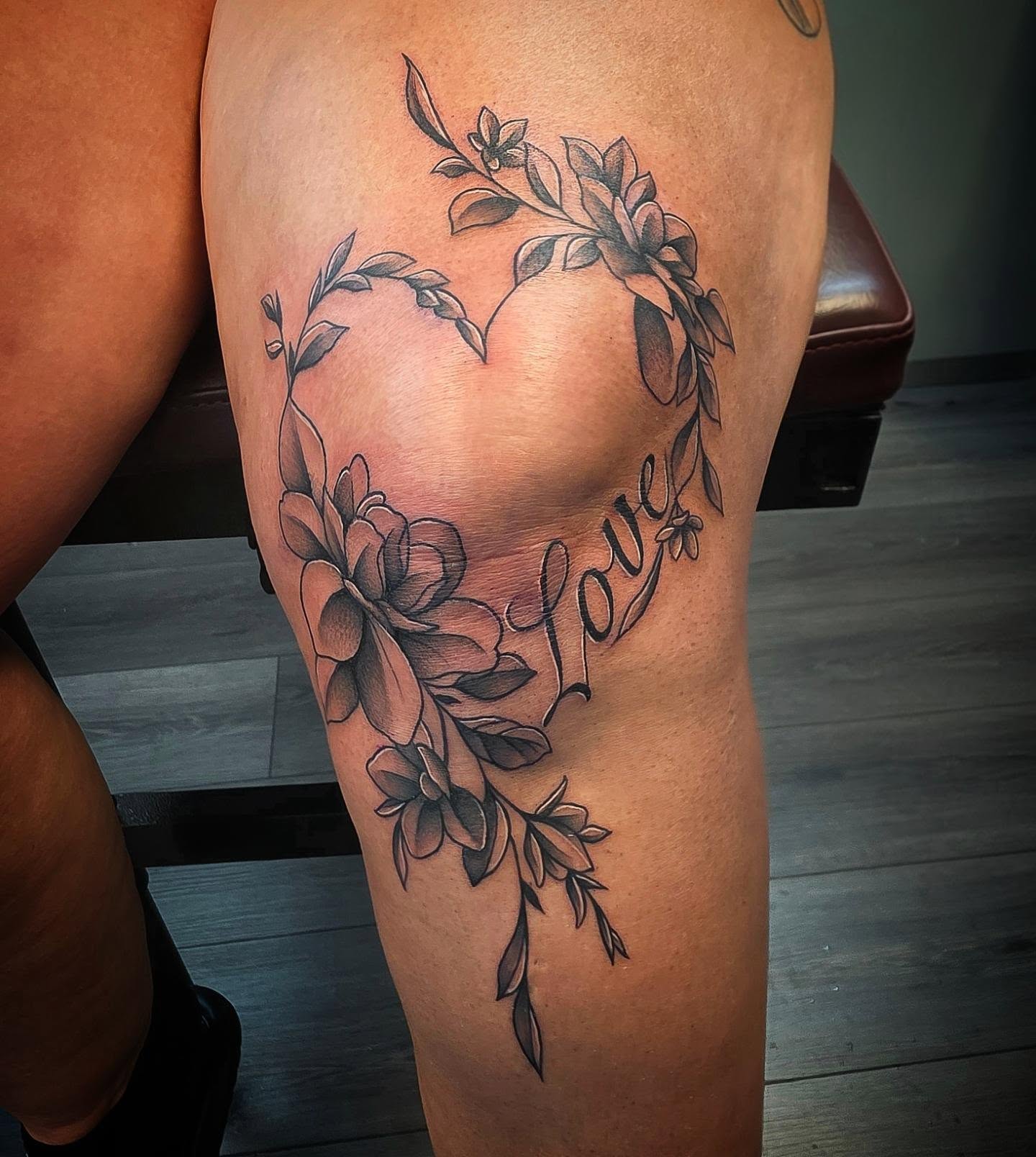 Flower heart black and grey tattoo on the thigh by Danielle Elizabeth