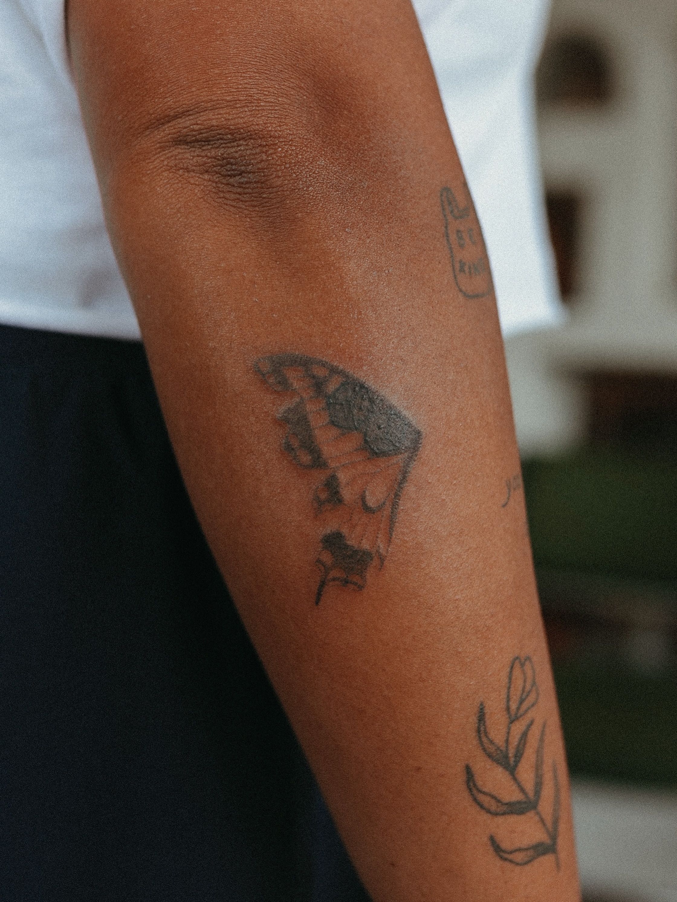 Abstract design black and grey tattoo on the forearm by Grace Wise - Handpoke Tattoos