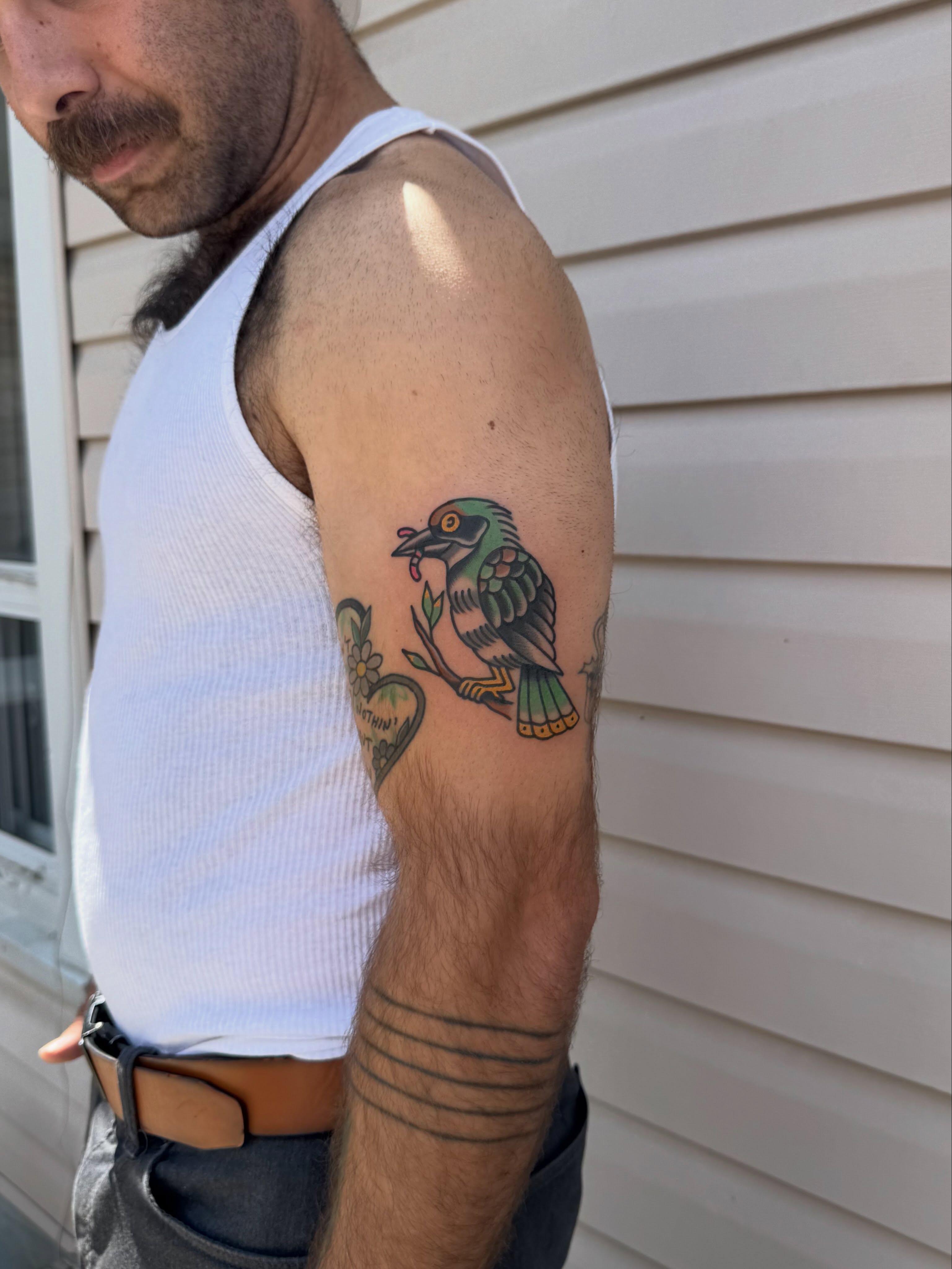 Bird American traditional tattoo on the forearm by Oldschool Tattooer