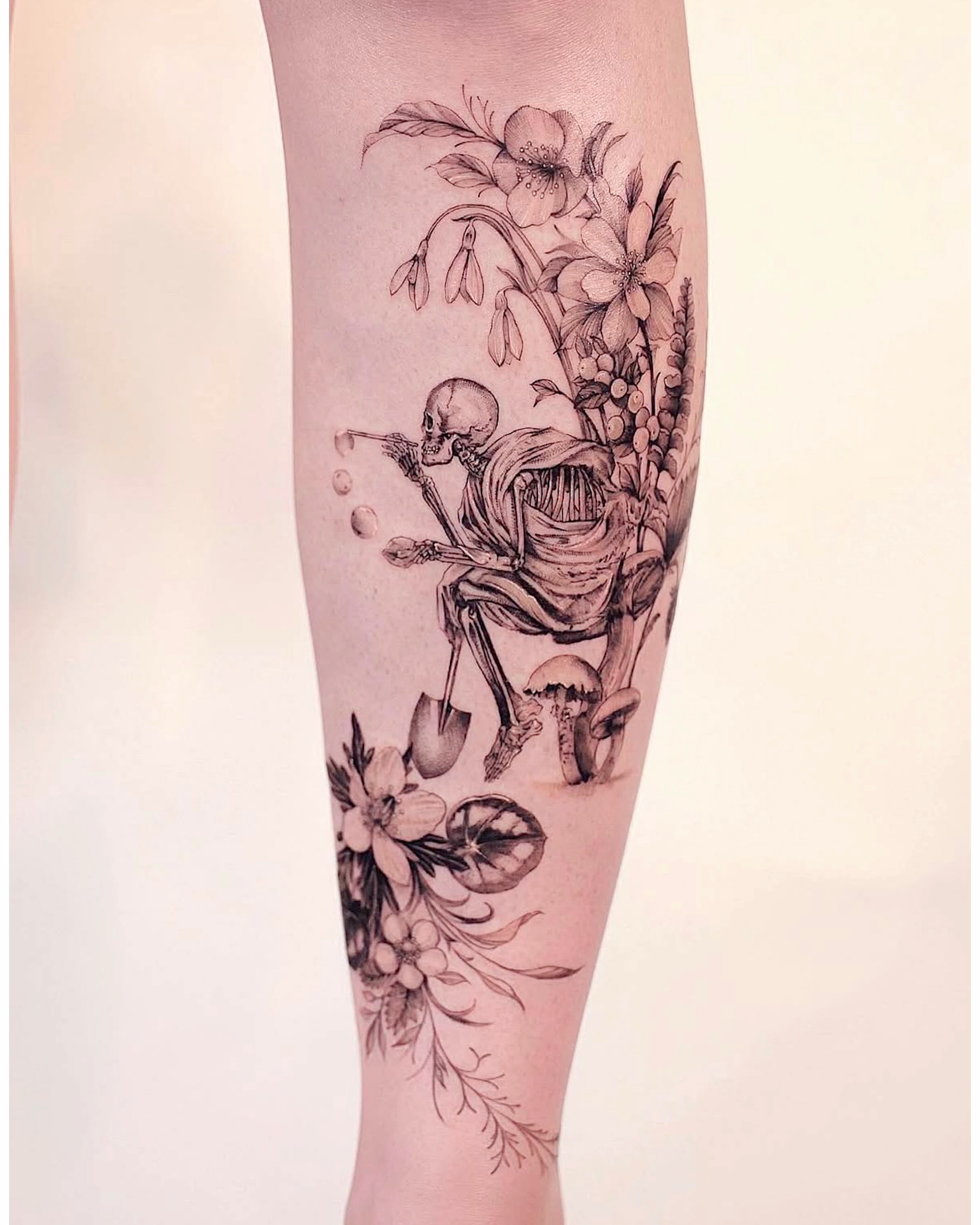 Skeleton with flowers realism tattoo on the calf by Lily, Los Angeles, California
