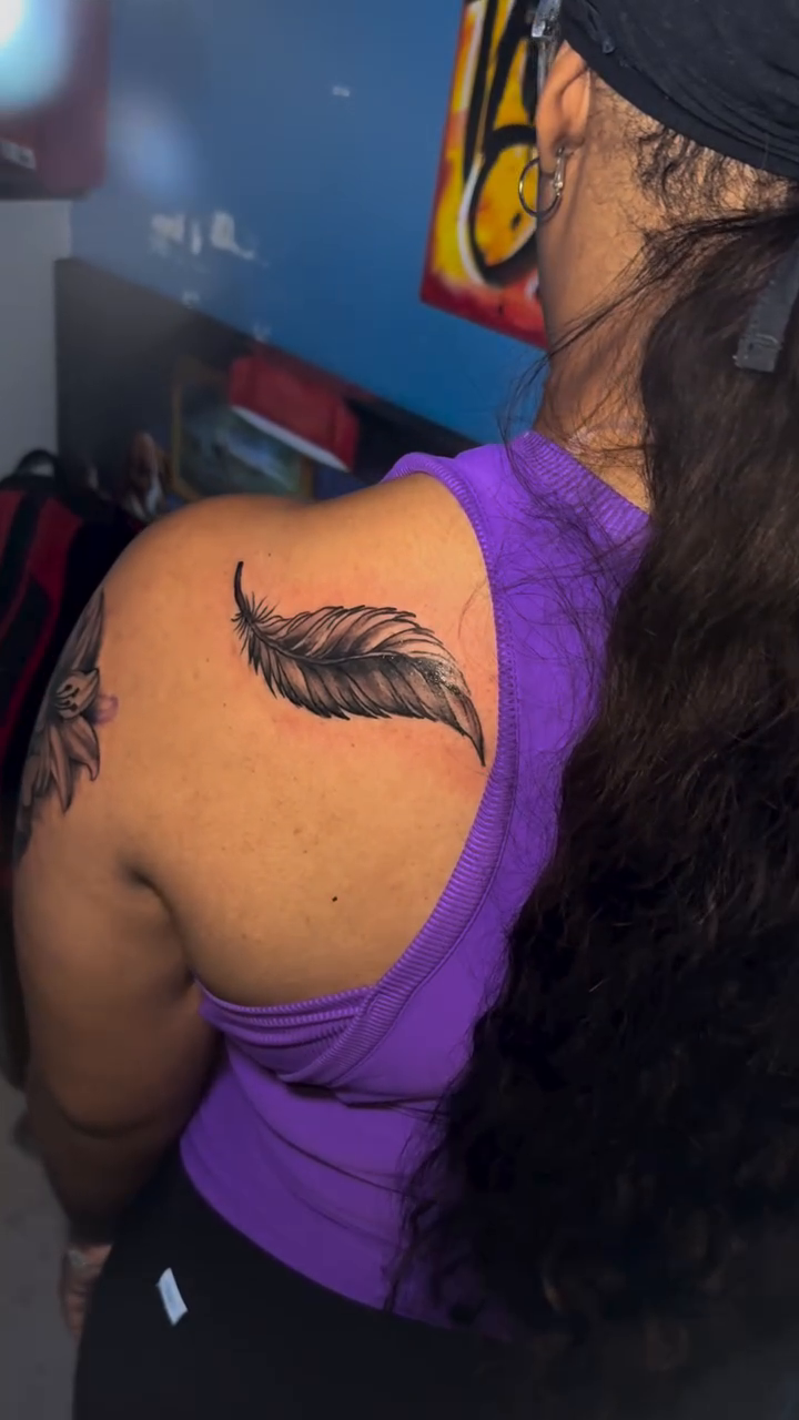 Feather fine line tattoo by Dope