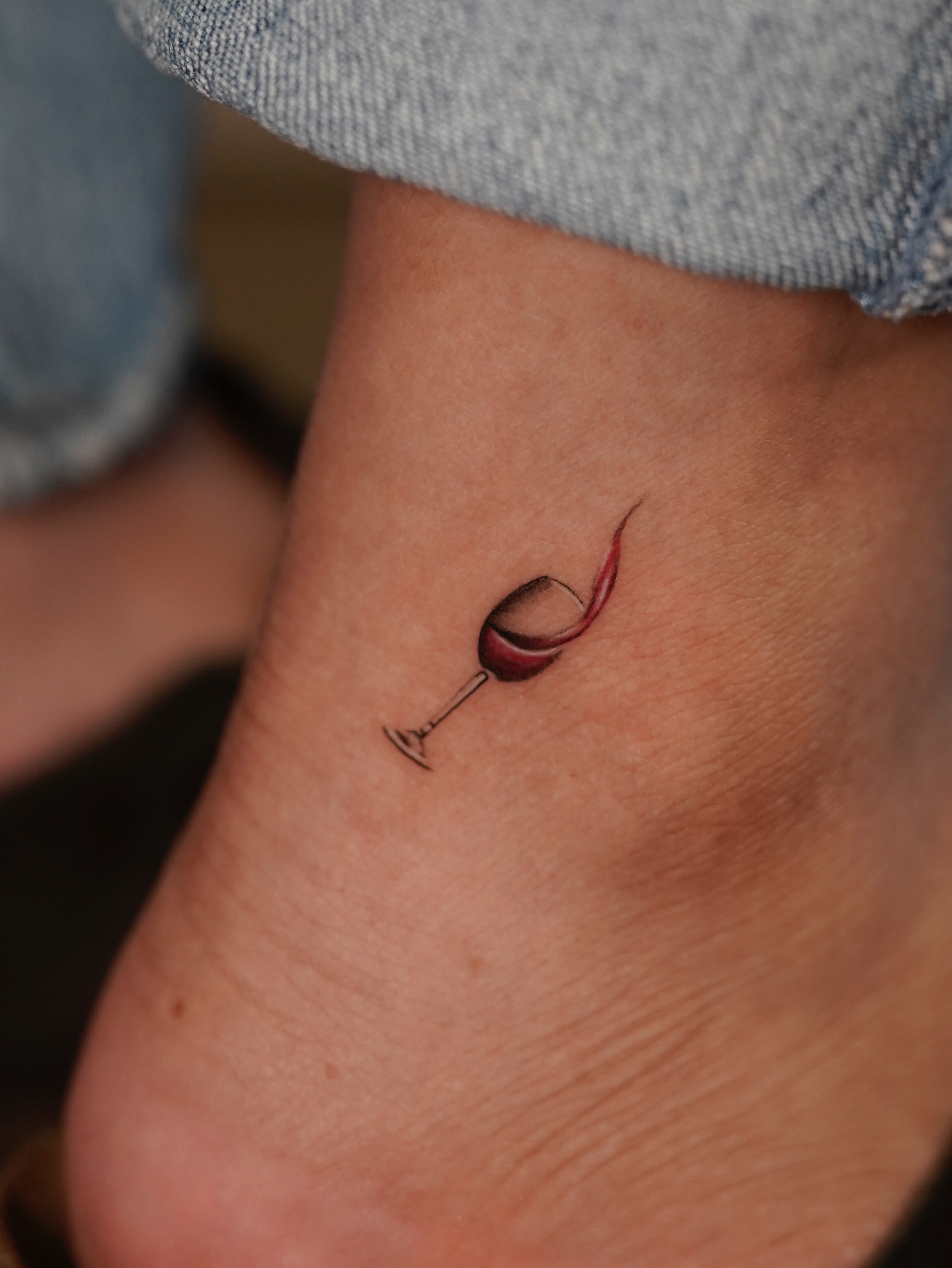 Wine glass realism tattoo on the foot by eddie chavez