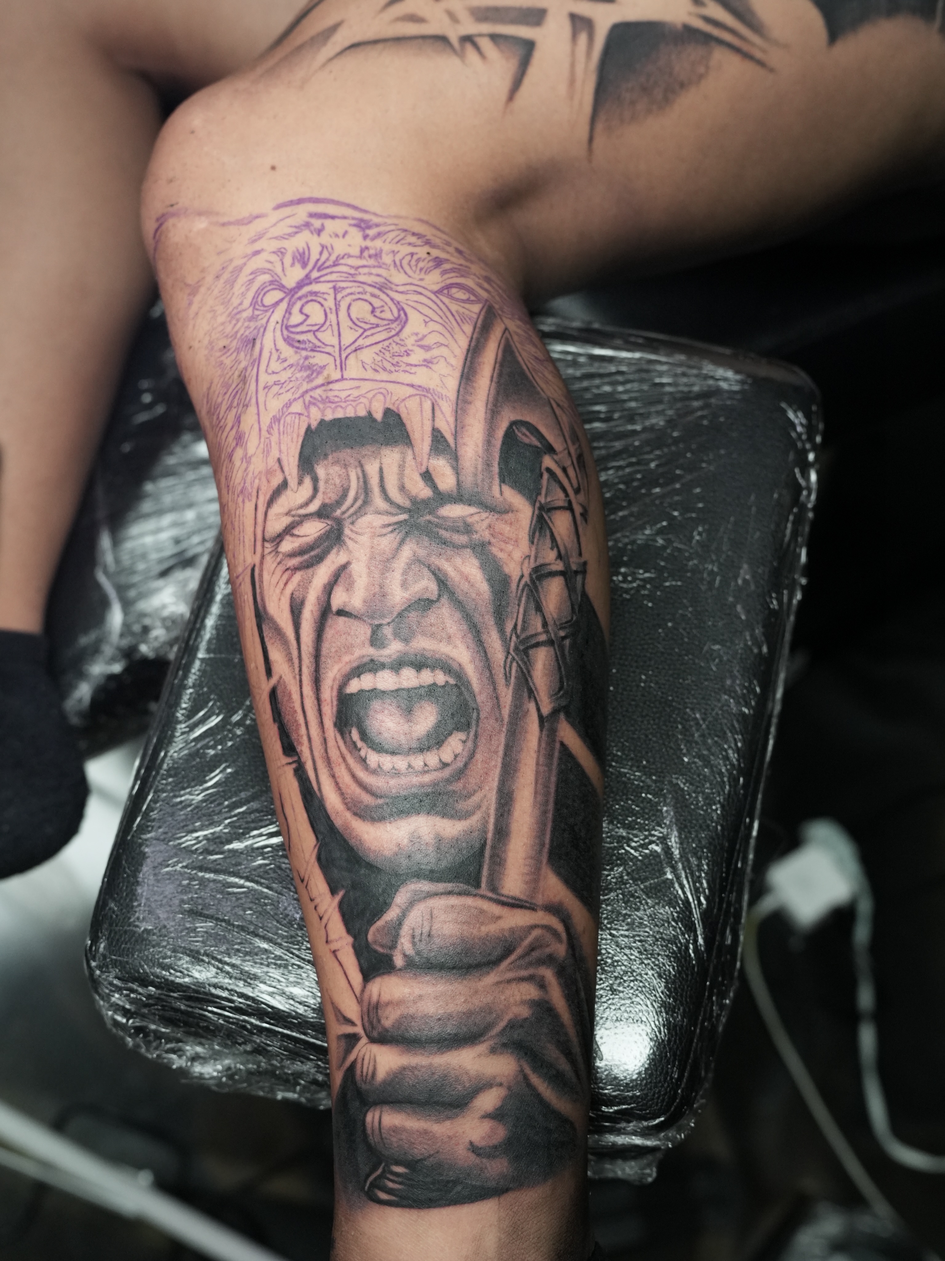 Angry face realism tattoo on the forearm by Alejo Ibanez Tattoo