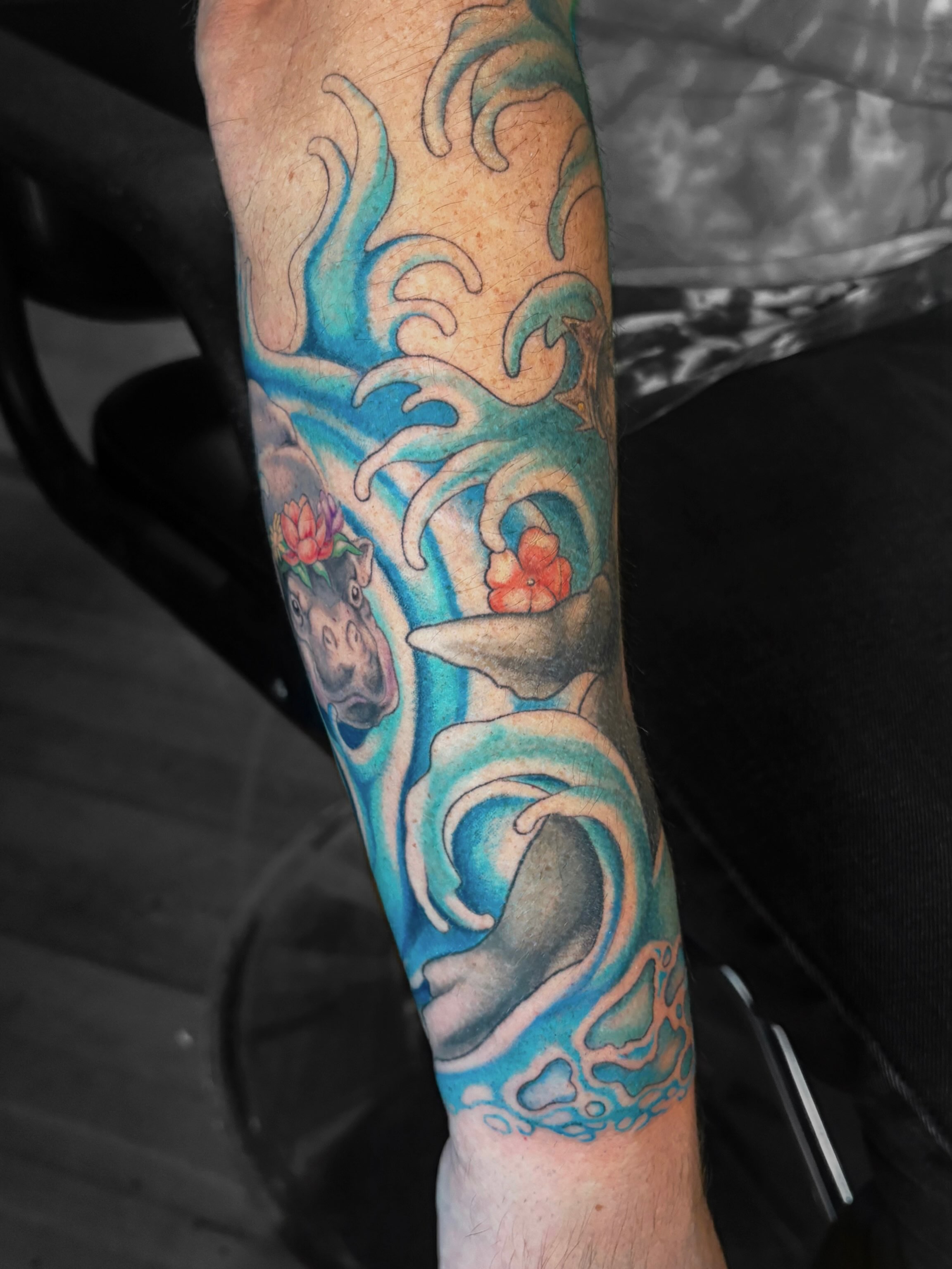 Wave and dolphin japanese irezumi tattoo on the forearm by Autumn