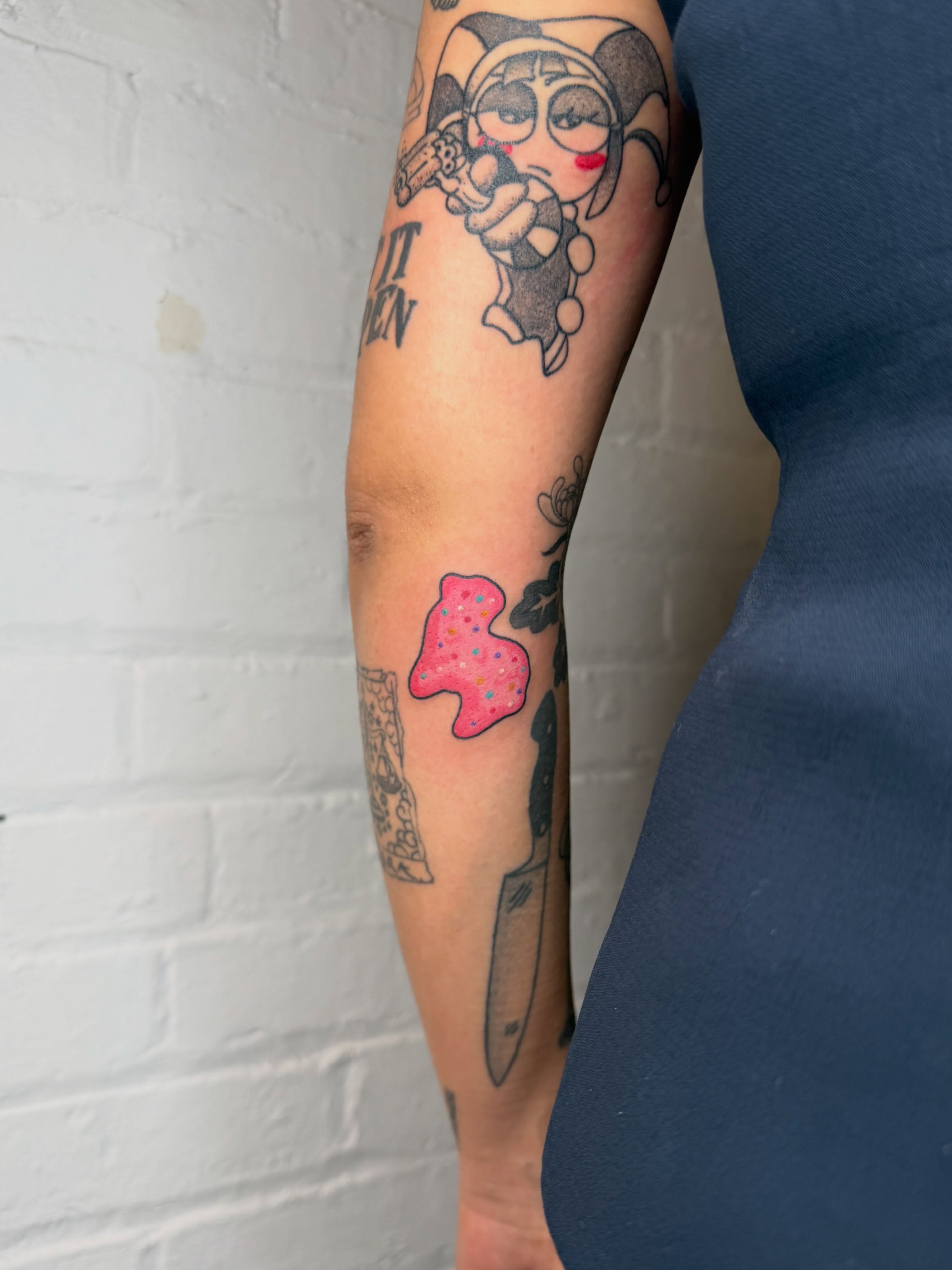 Joker character American traditional tattoo on the forearm by Dennis Patterson