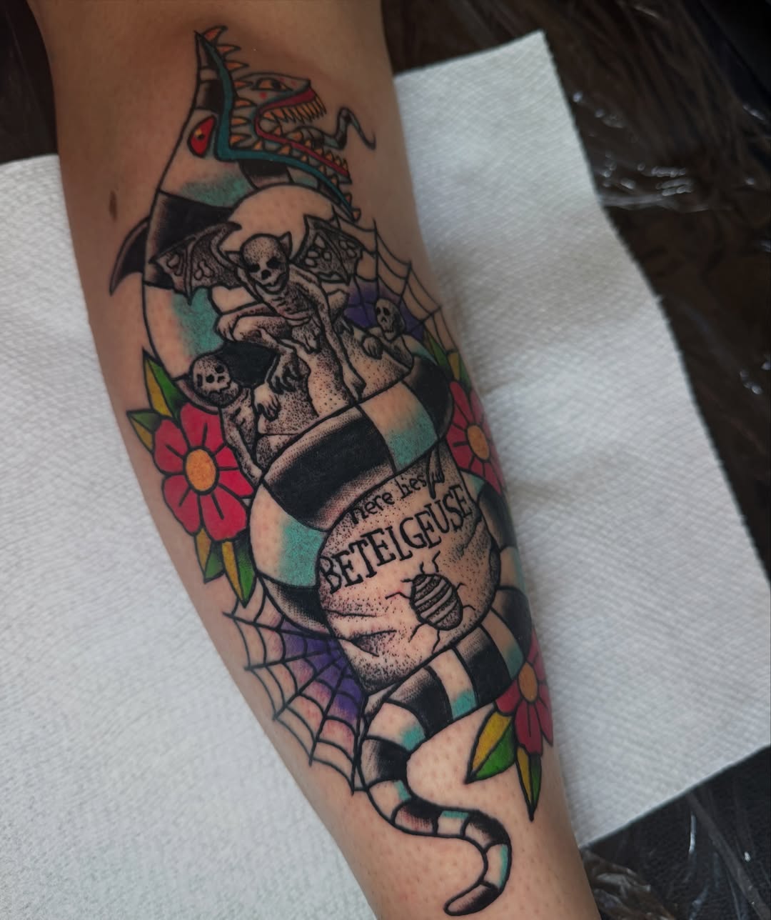 Skull and bat American traditional tattoo on the forearm by Oliver Ⴟ Graves