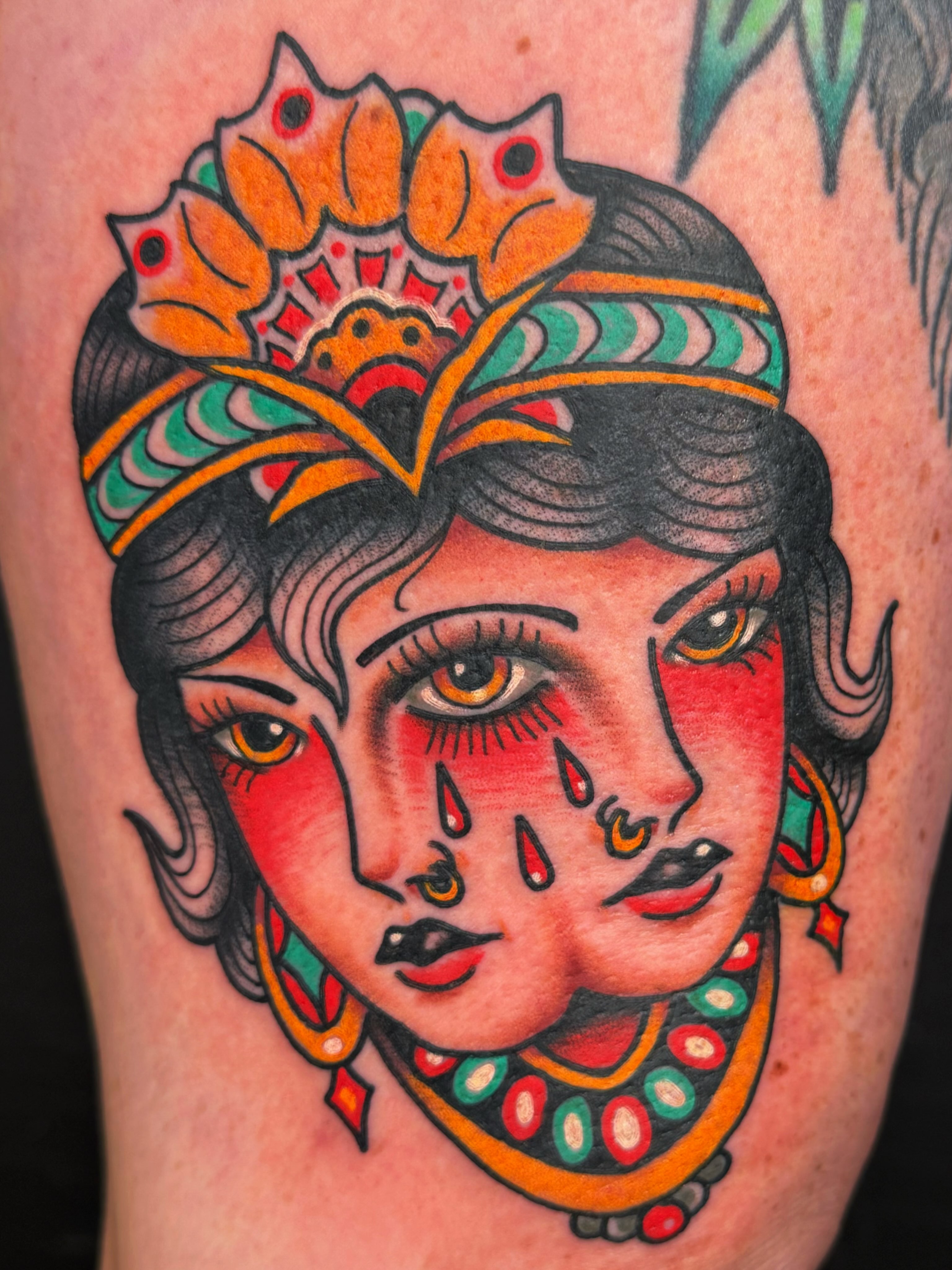 Woman with floral crown American traditional tattoo on the thigh by Mikey Sarratt
