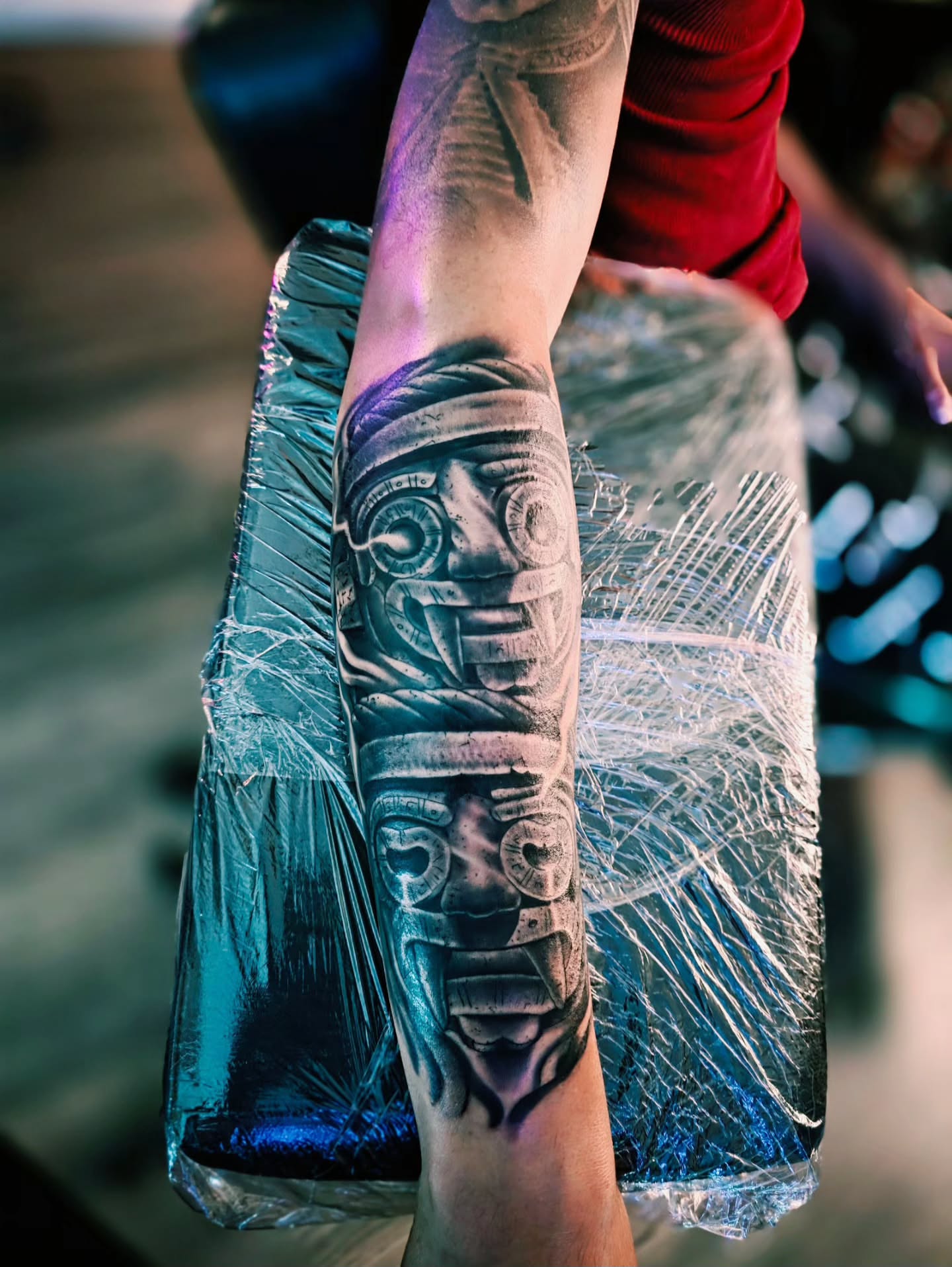 Ancient mask black and grey tattoo on the forearm by Luke Jordan Ink, Louisville, Colorado