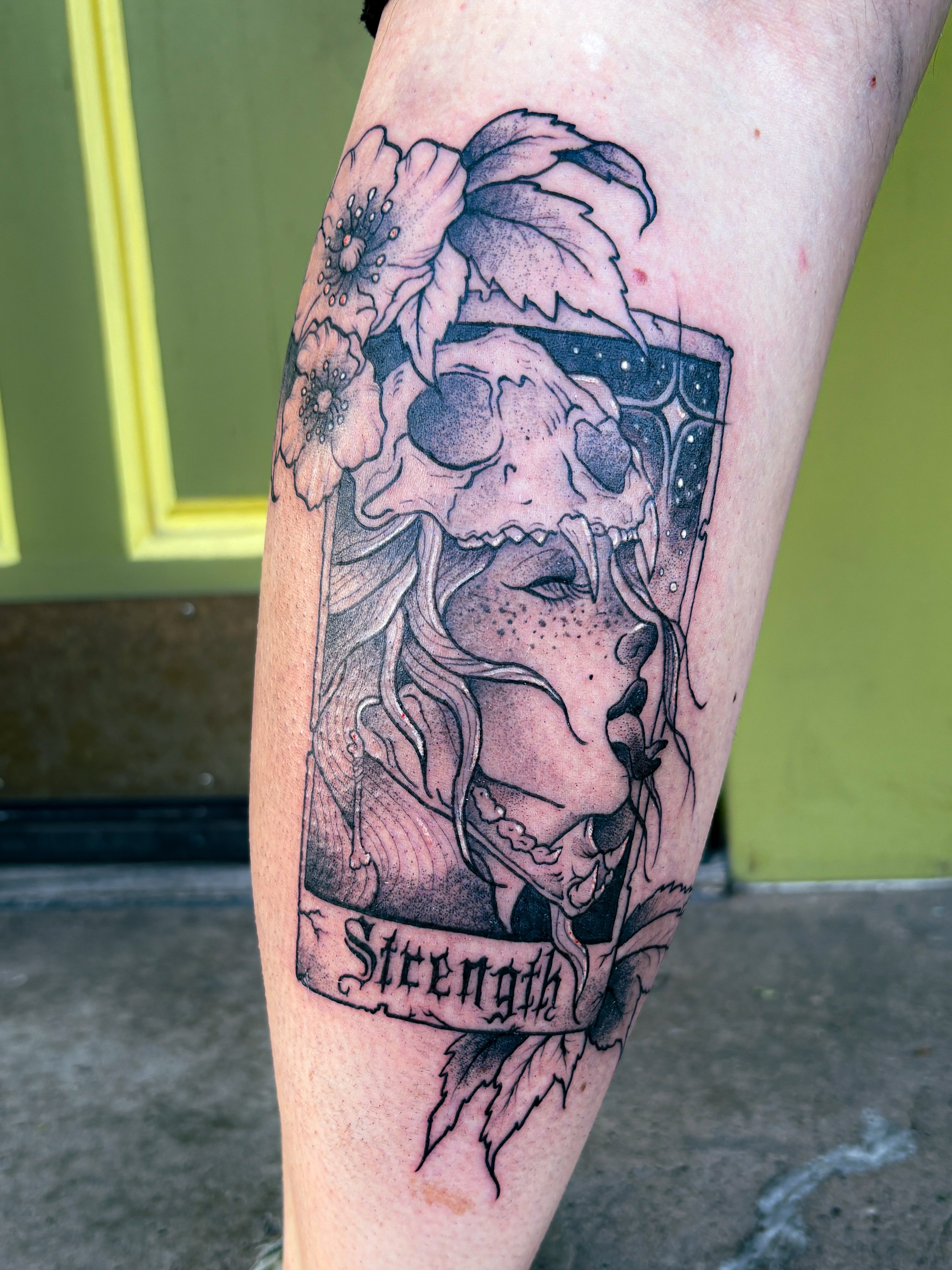 Strength card realism tattoo on the forearm by Liz Cook