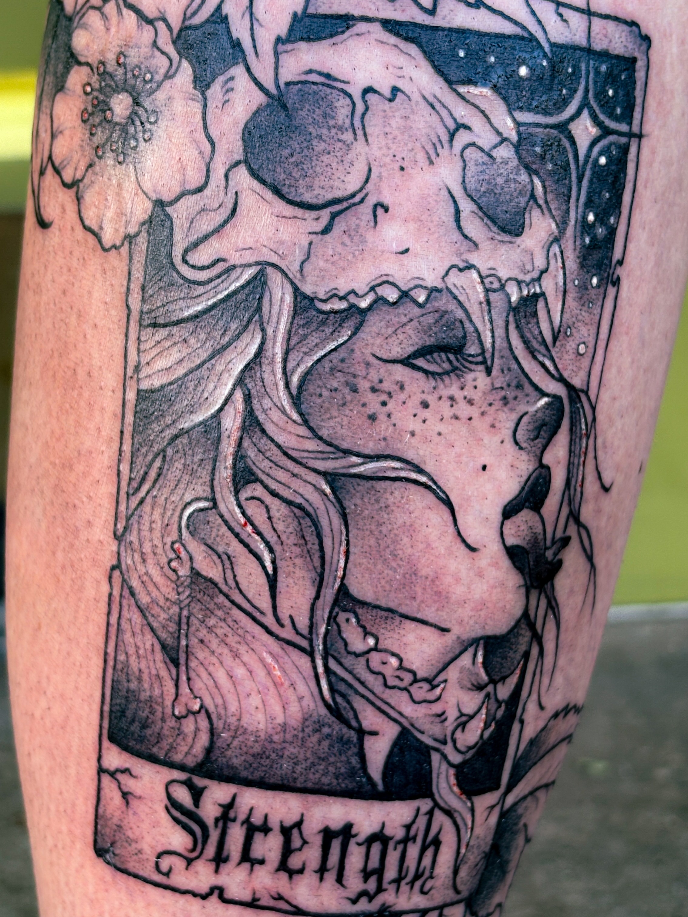 Strength tarot card realism tattoo on the forearm by Liz Cook