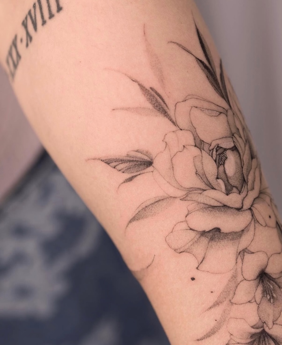 Flower black and grey tattoo on the forearm by Tattooist hea