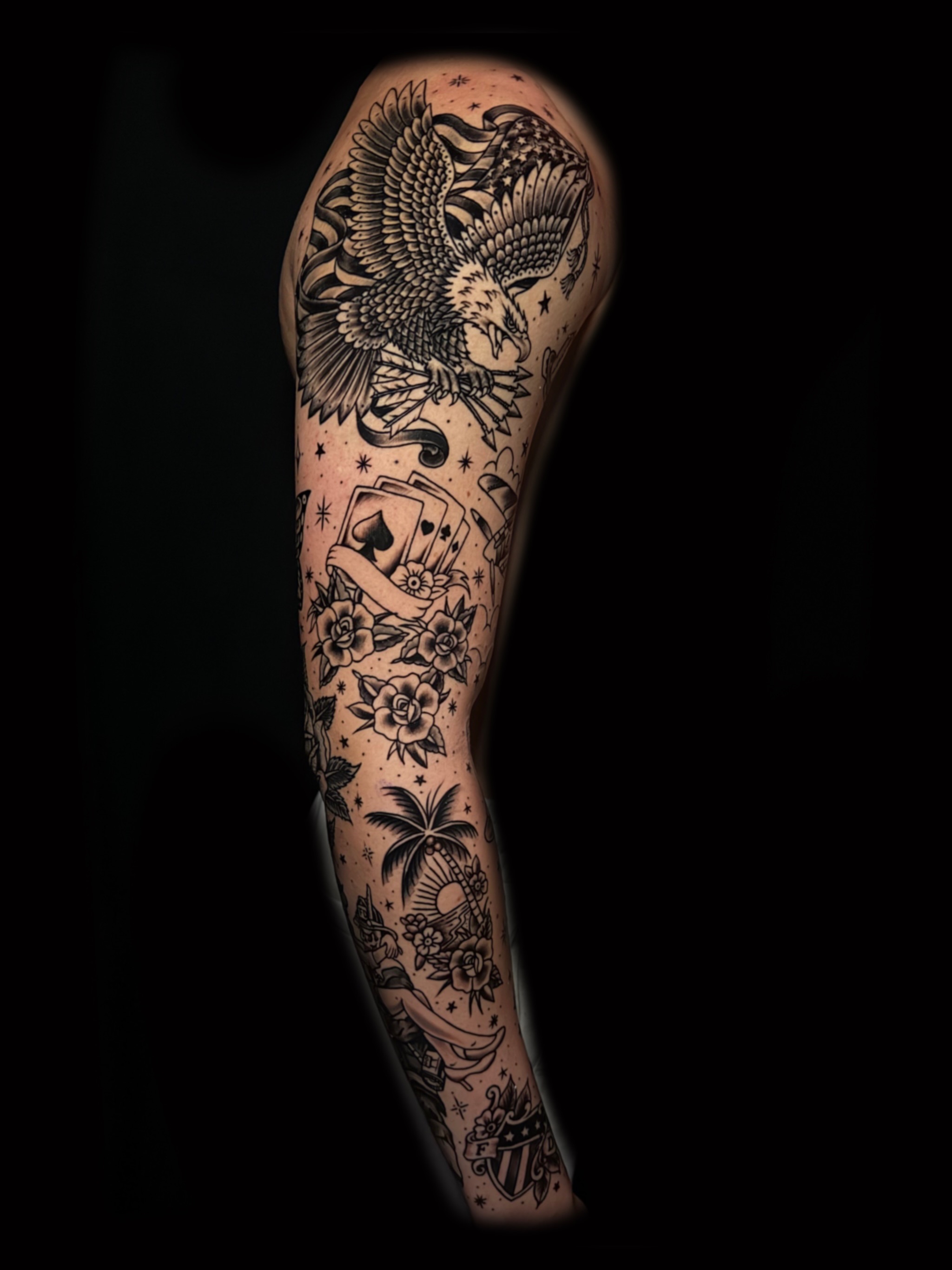 Eagle and playing cards American traditional tattoo on the forearm by Alex