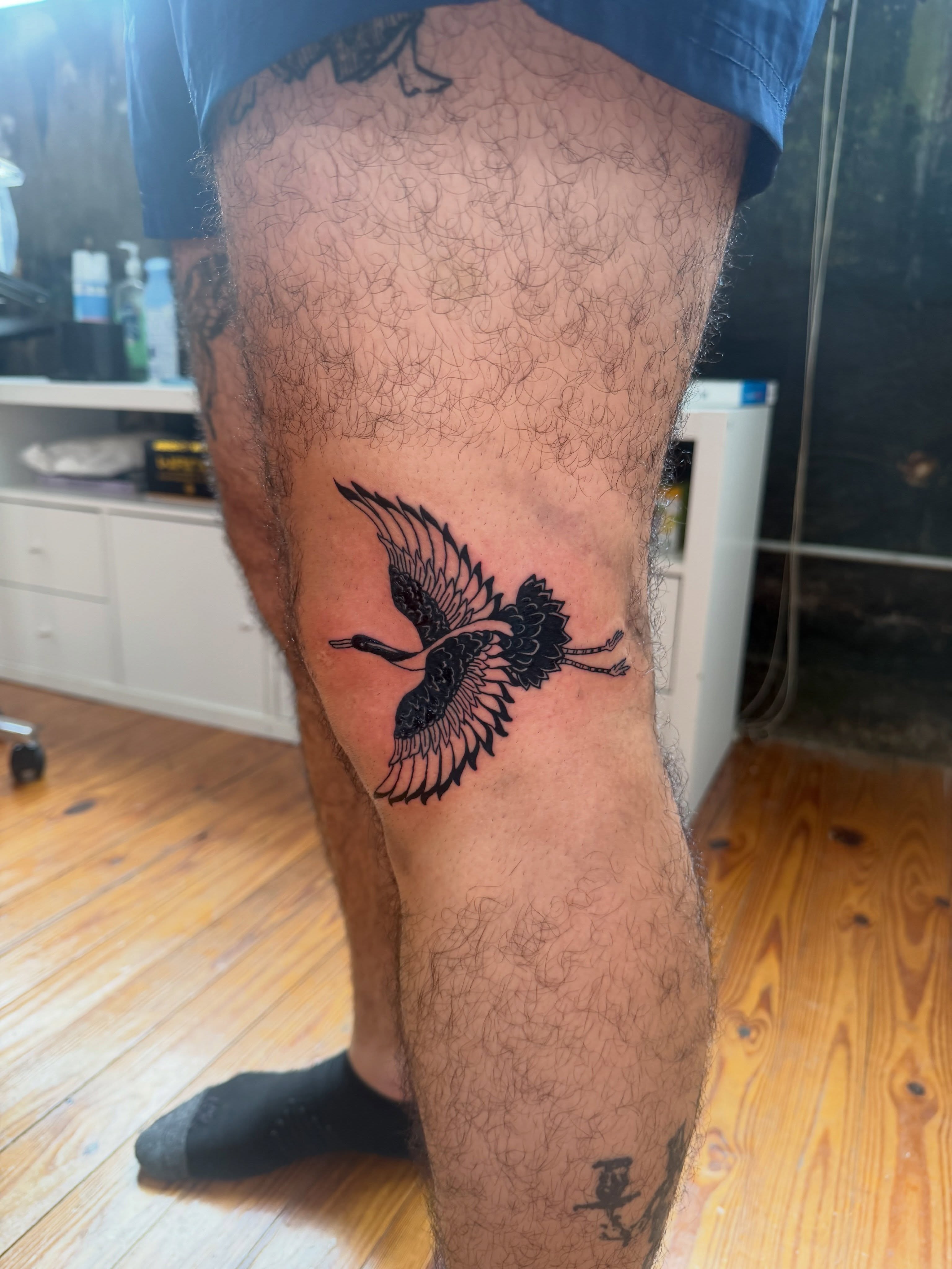 Bird black and grey tattoo on the thigh by Jose Javier