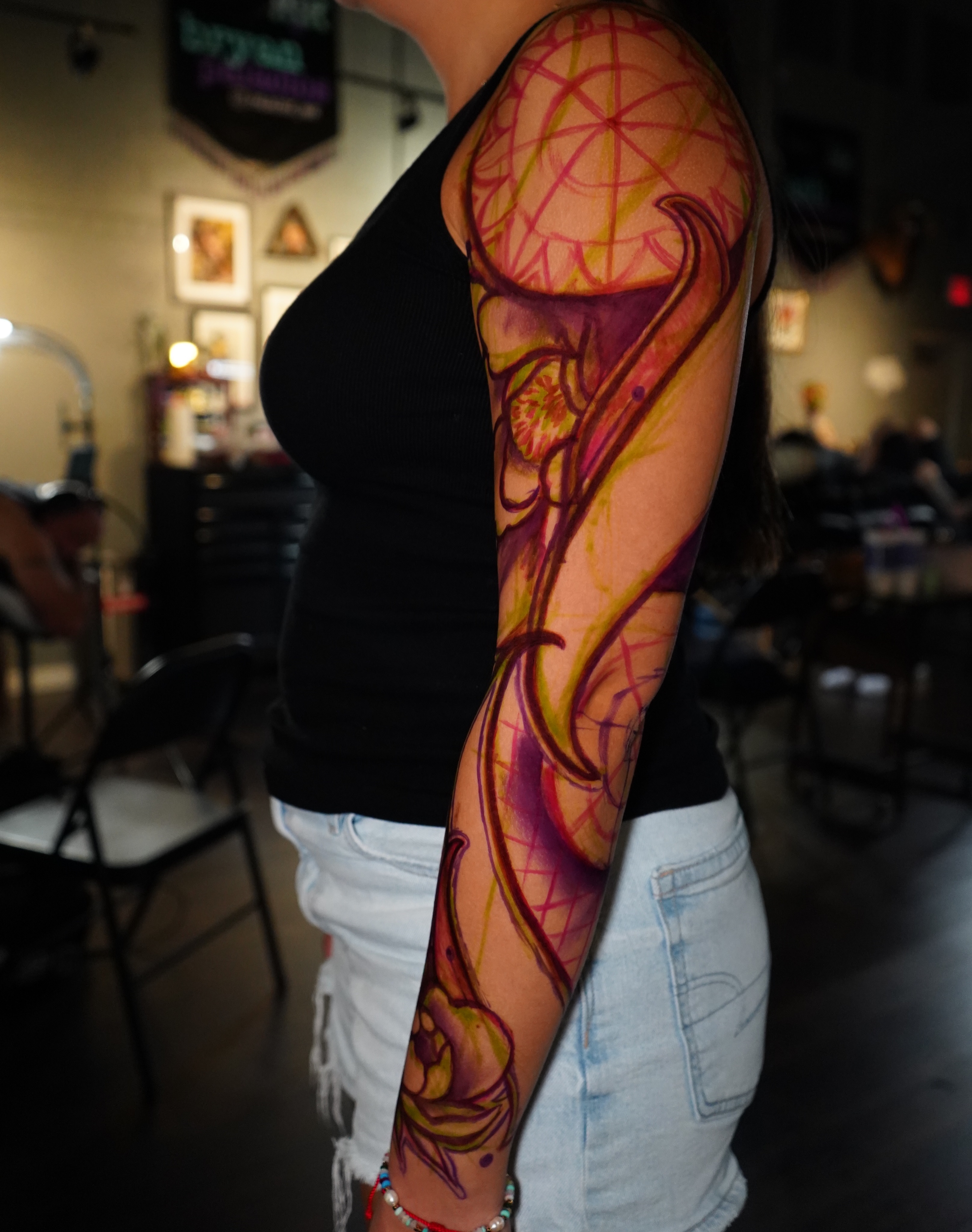 Abstract design watercolor tattoo on the upper arm by Haley Corinne