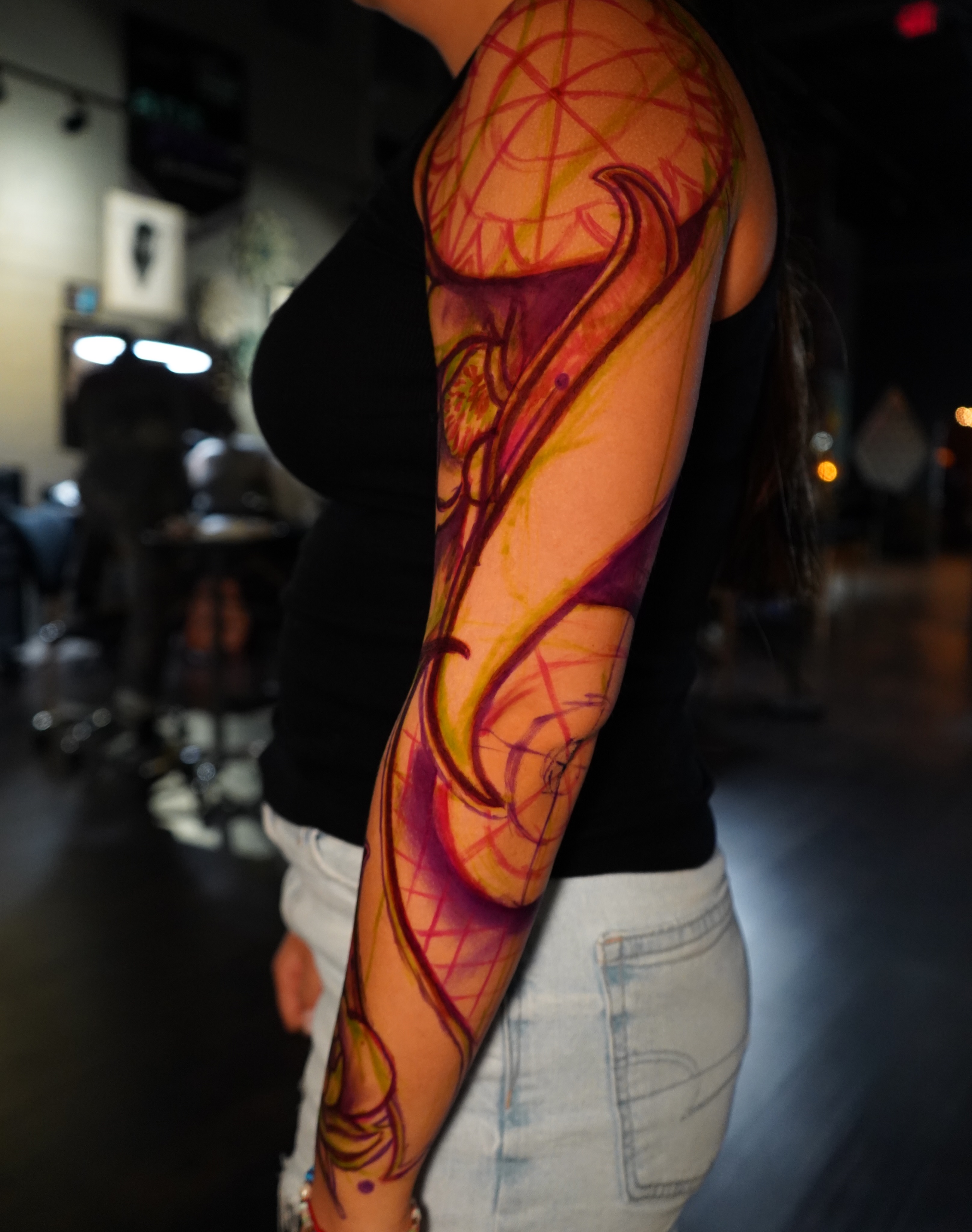Abstract swirls watercolor tattoo on the forearm by Haley Corinne