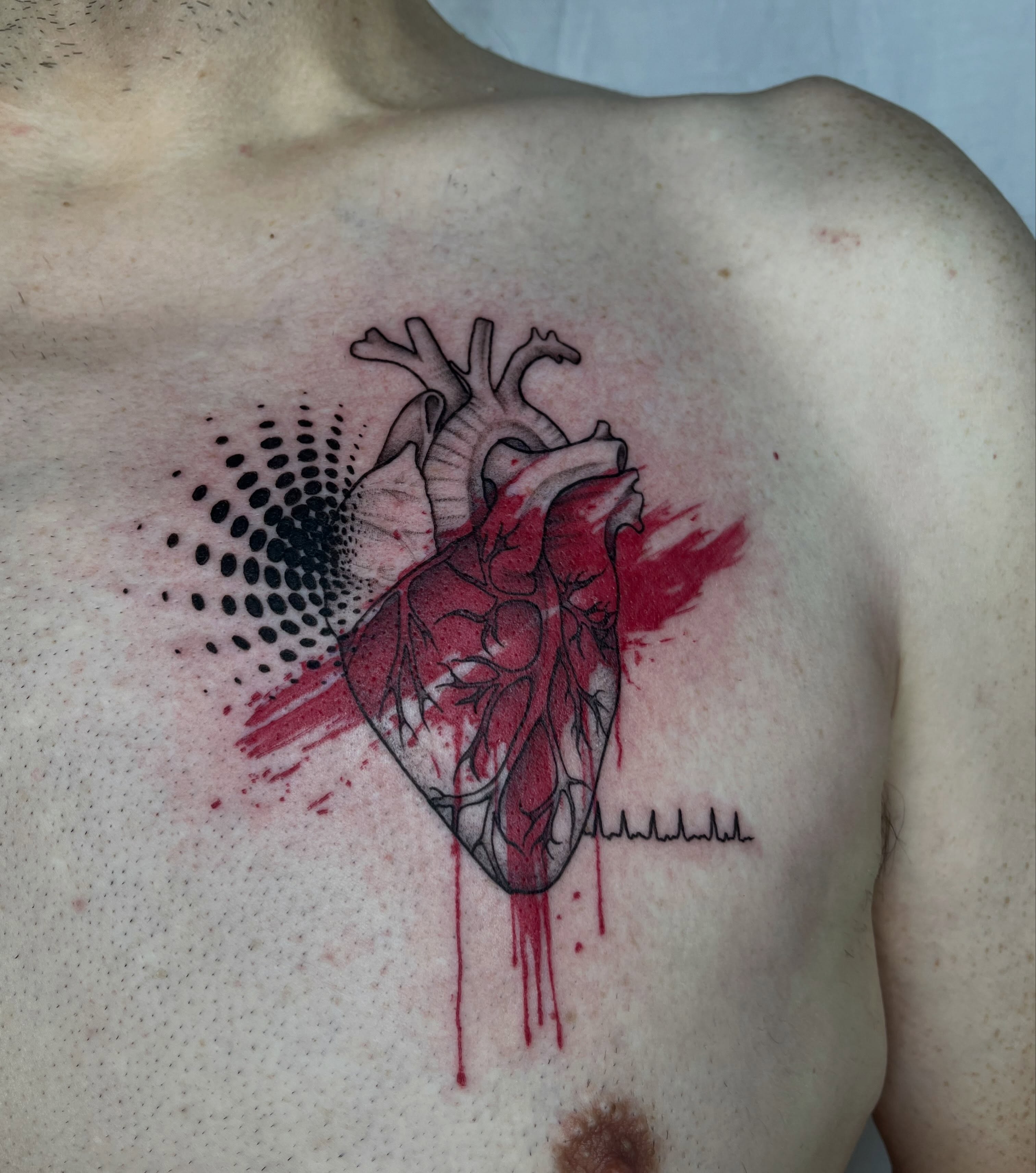 Heart dotwork tattoo on the chest by Ty’s Tattoos