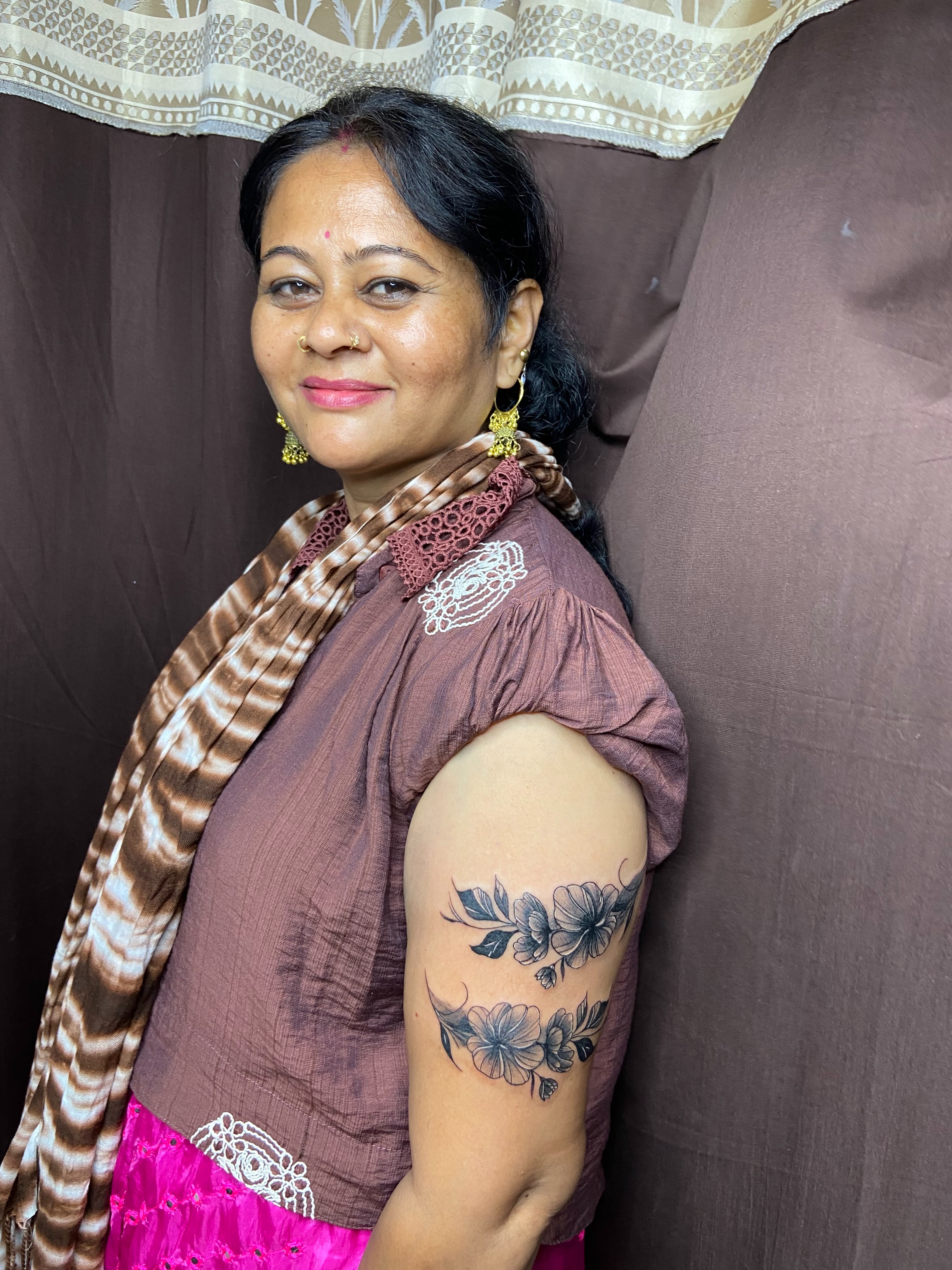 Floral black and grey tattoo on the upper arm by VR tattoo Studio