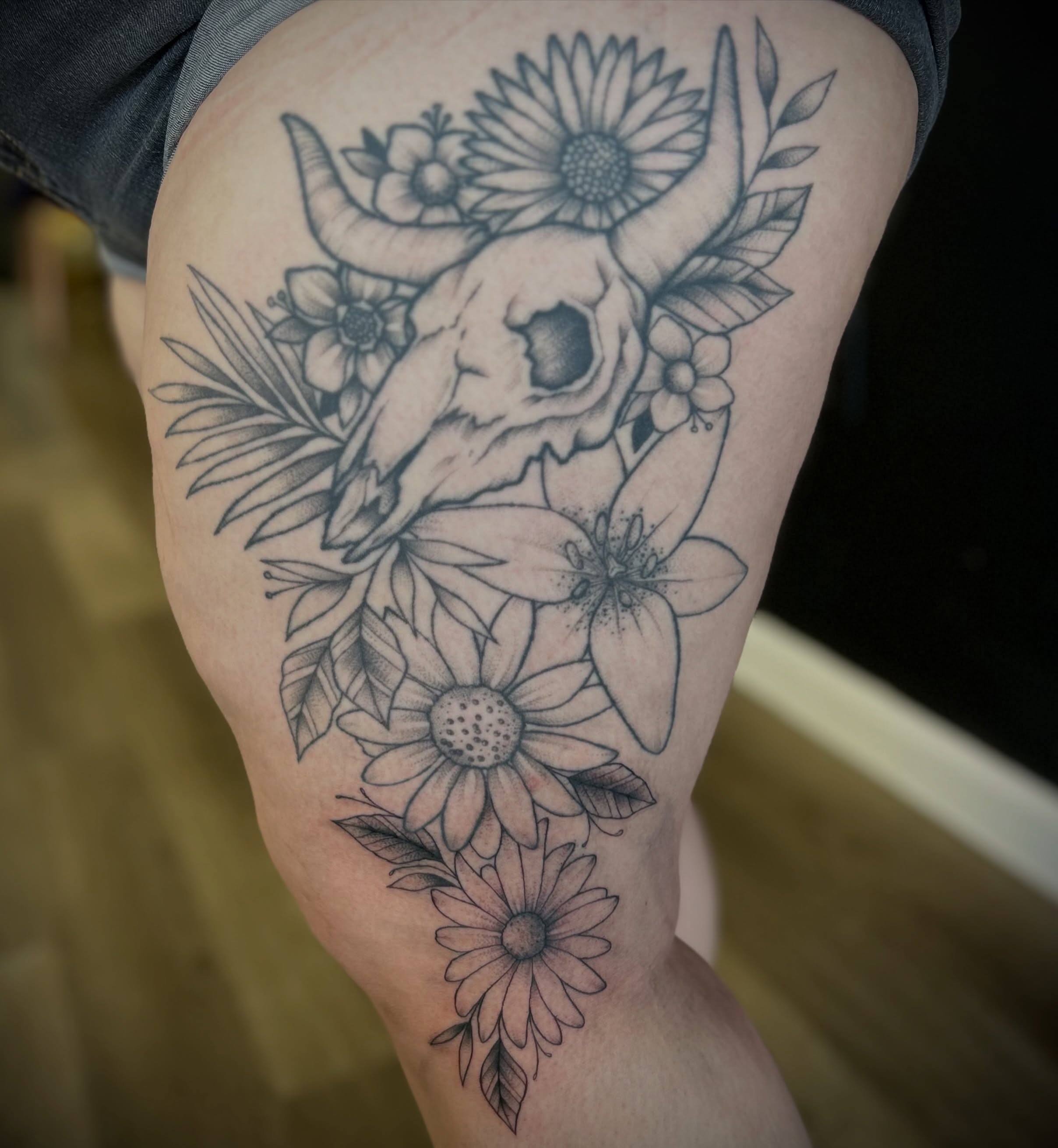 Bull skull with flowers realism tattoo on the thigh by Browtique & Ink, Clearwater, Florida