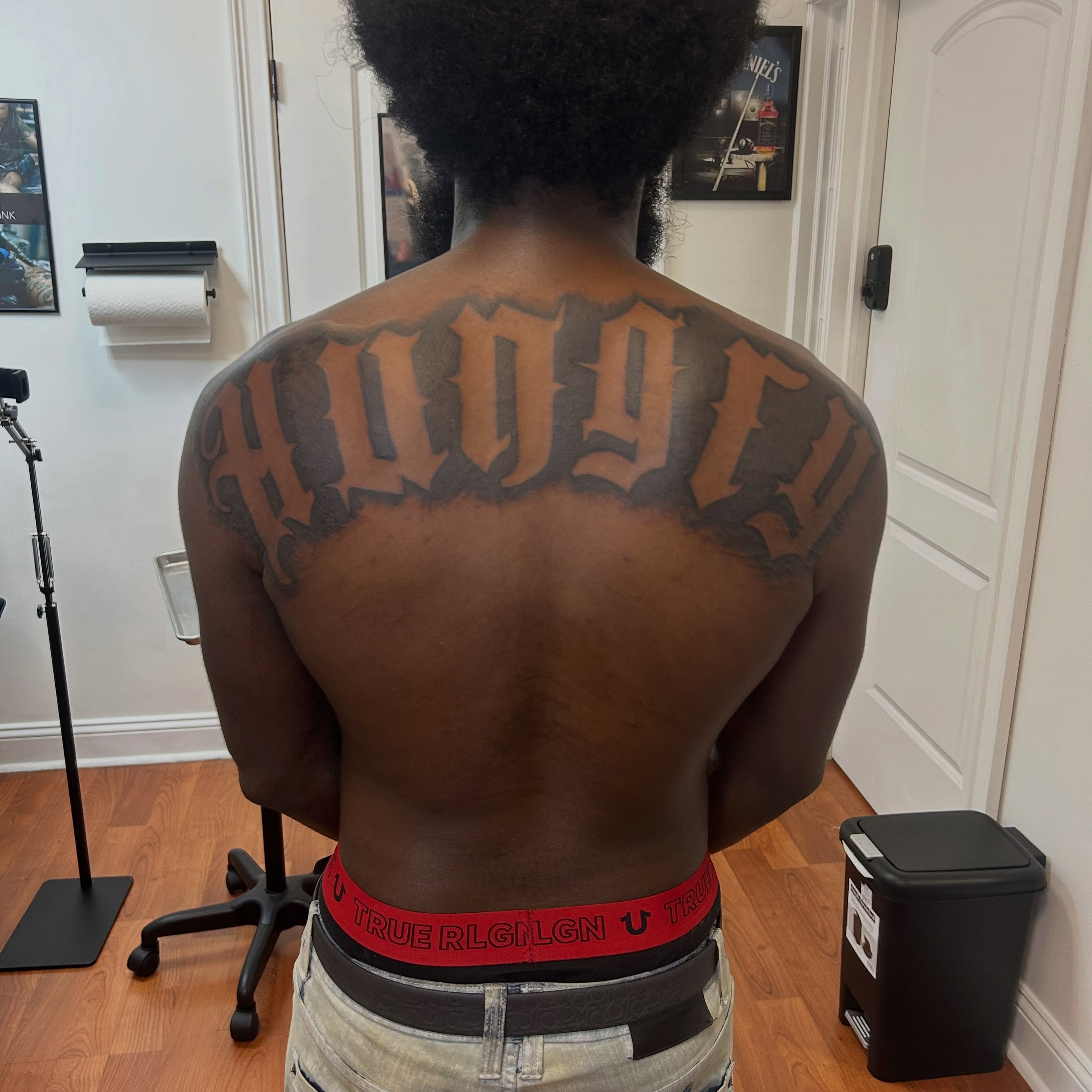 Script lettering lettering script tattoo on the back by Still Standing. Still Creating. 🖤