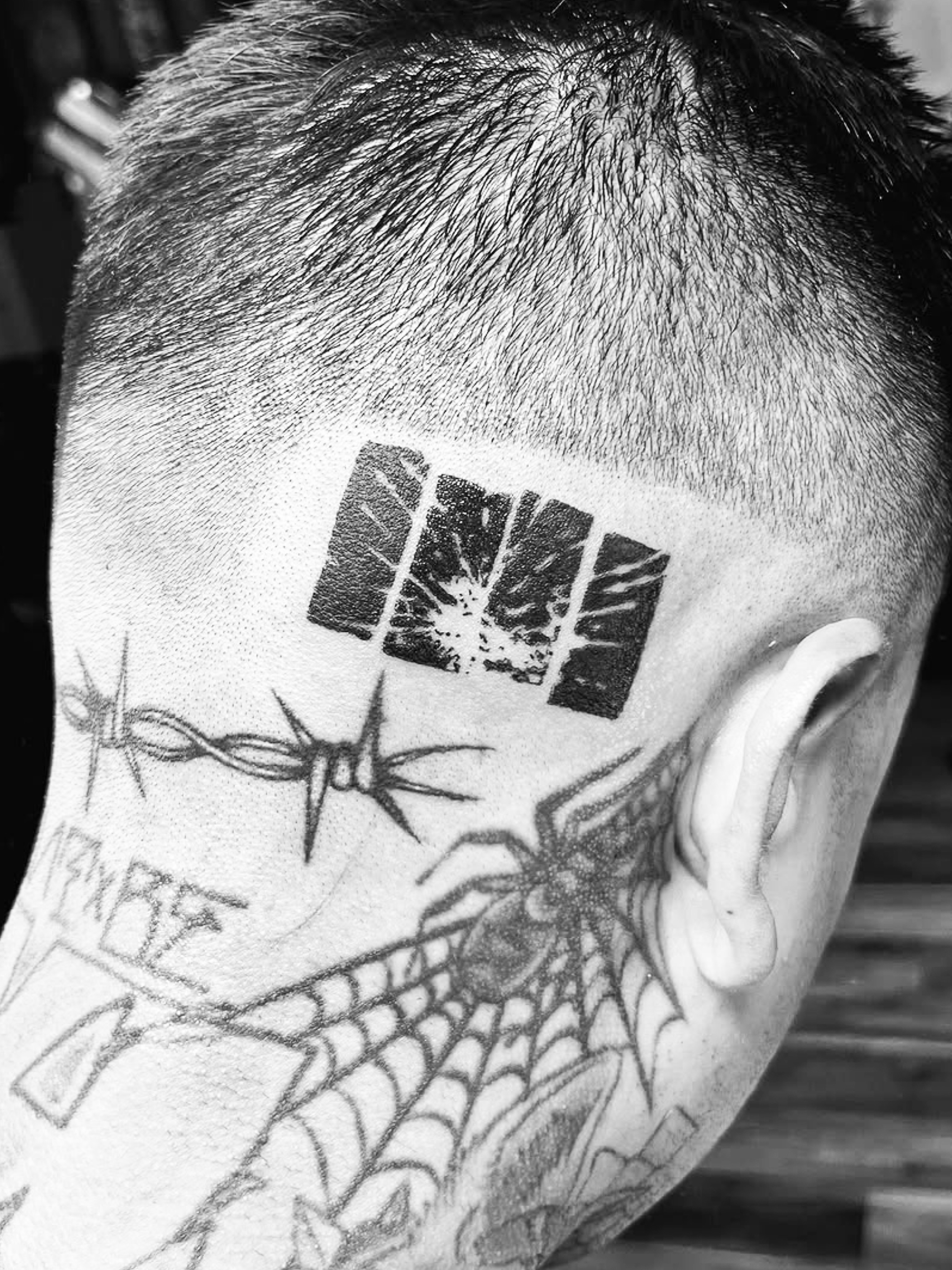 Barbed wire, spider web, skull black and grey tattoo on the head by Jack Hatchet Tattoos