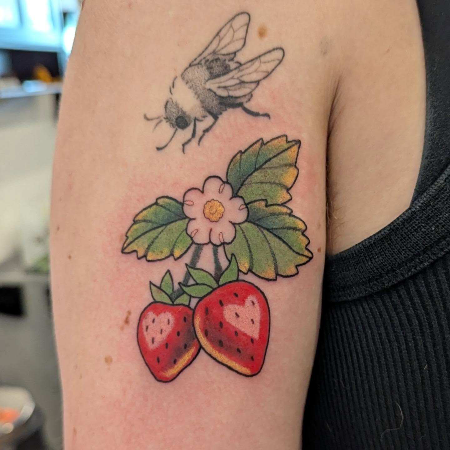 Strawberries and bee American traditional tattoo on the forearm by Spencer Jennings, Westland, Michigan