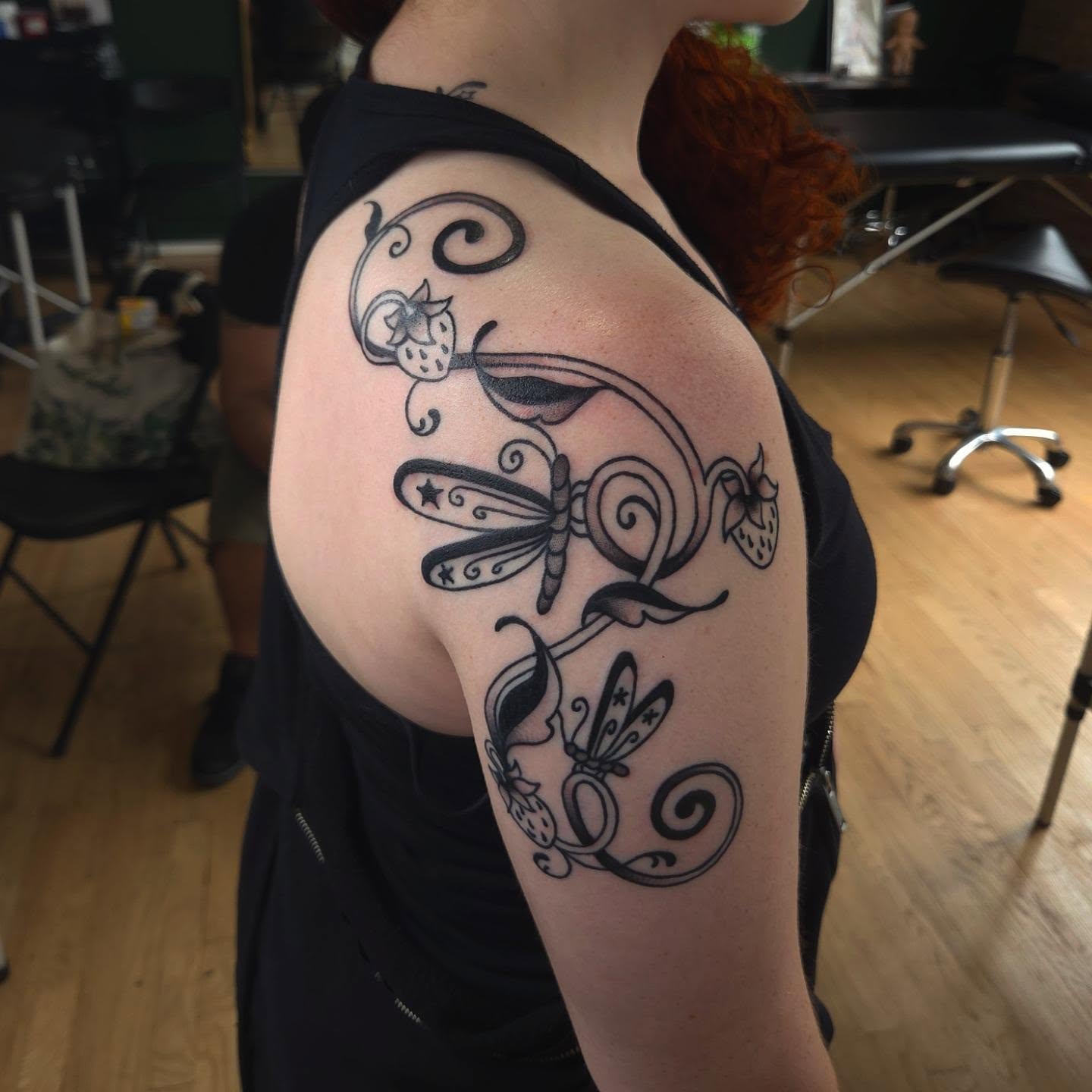 Dragonfly and strawberries ornamental tattoo on the shoulder by Maxine Stewart
