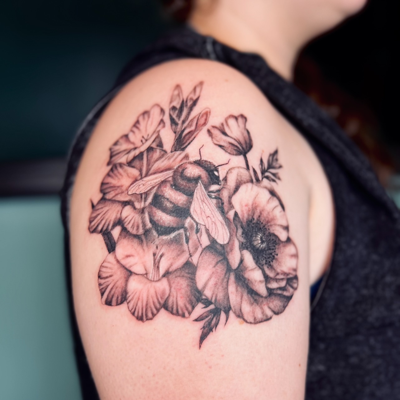 Bee and flowers realism tattoo on the shoulder by Sydney Rose