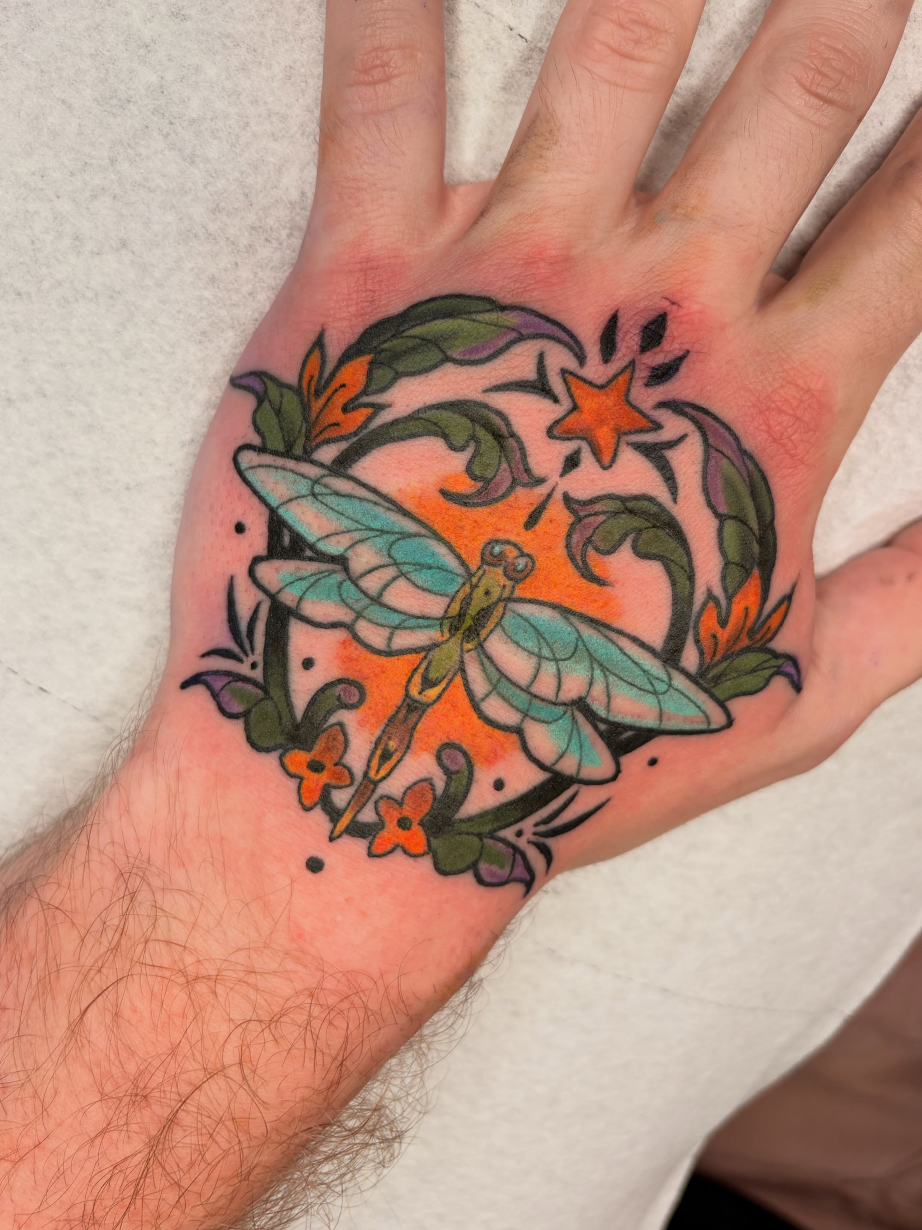 Dragonfly American traditional tattoo on the hand by Allyson Blessing Tattoos
