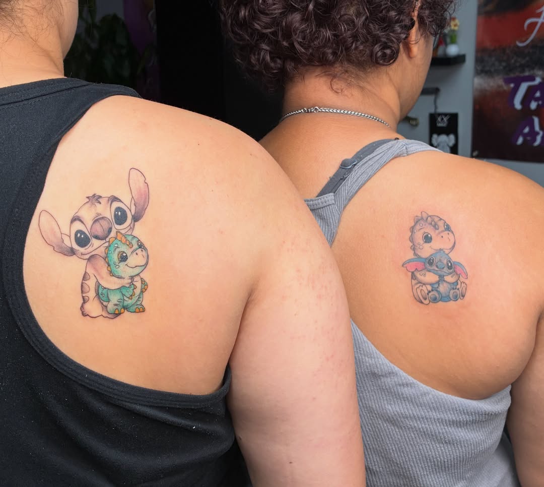 Stitch and dinosaur dotwork tattoo on the shoulder by Tattoos by Hailey