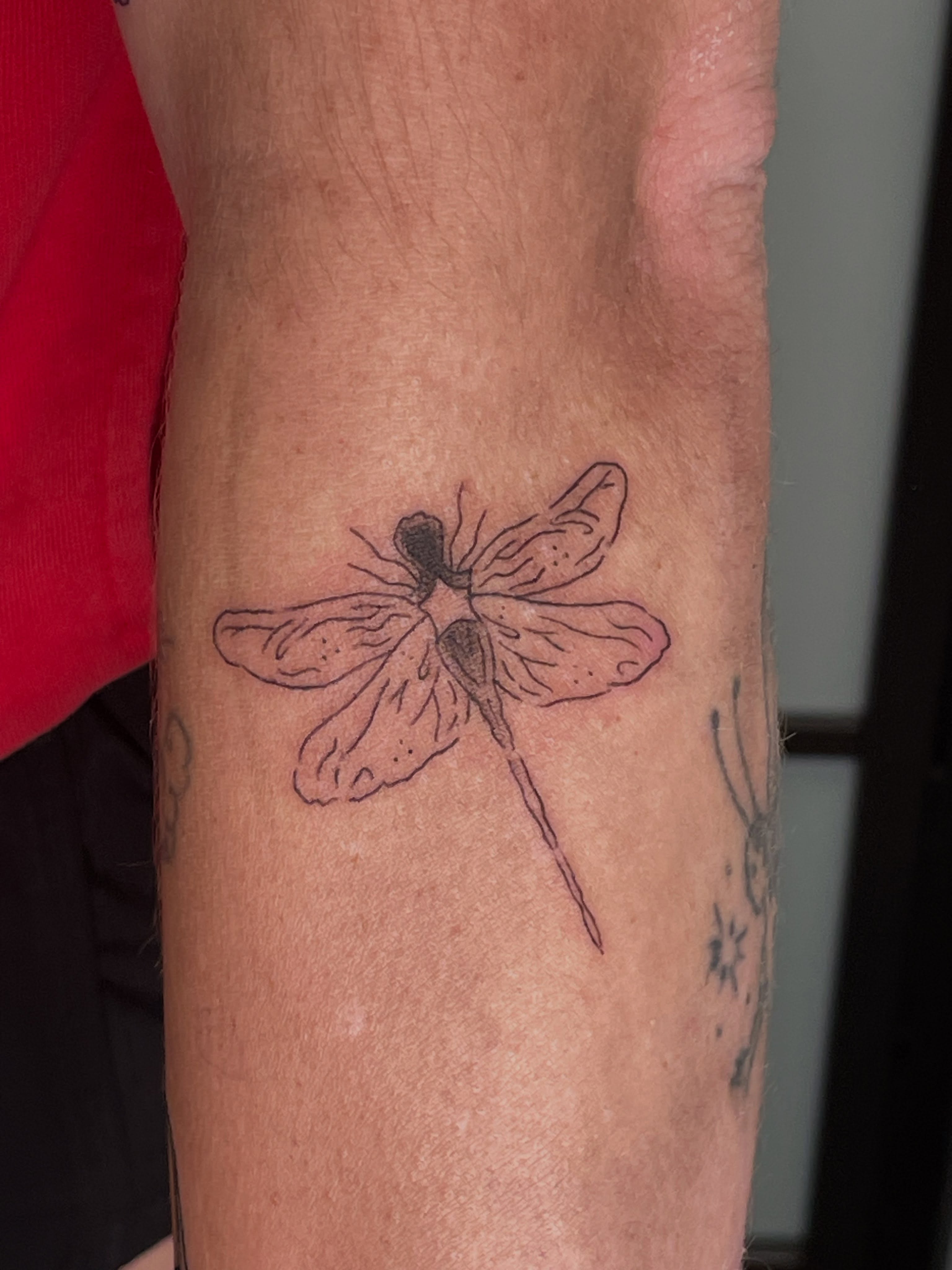 Dragonfly dotwork tattoo on the forearm by Gel Clark