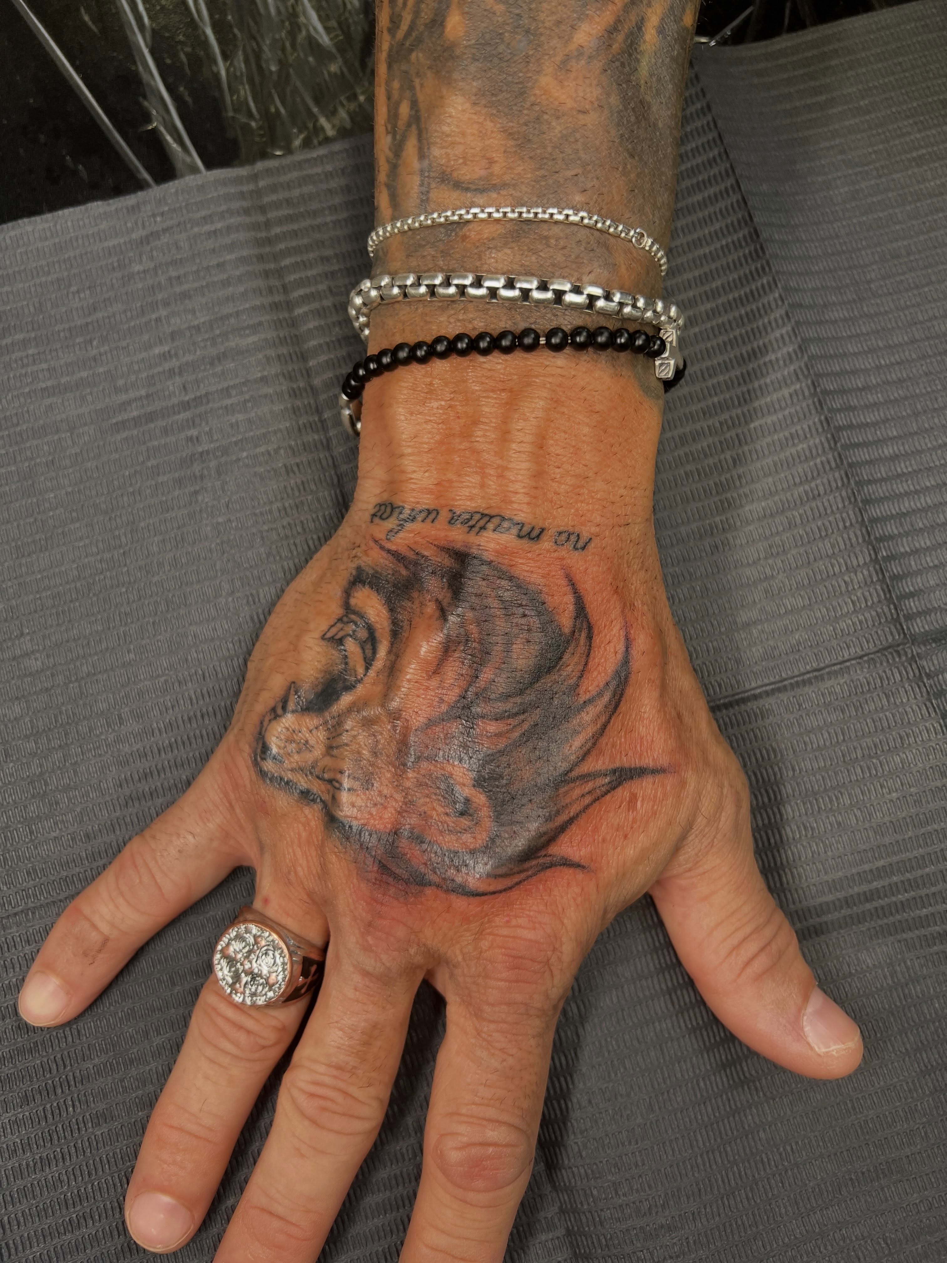 Lion black and grey tattoo on the hand by Presley Tattoos, Murfreesboro, Tennessee
