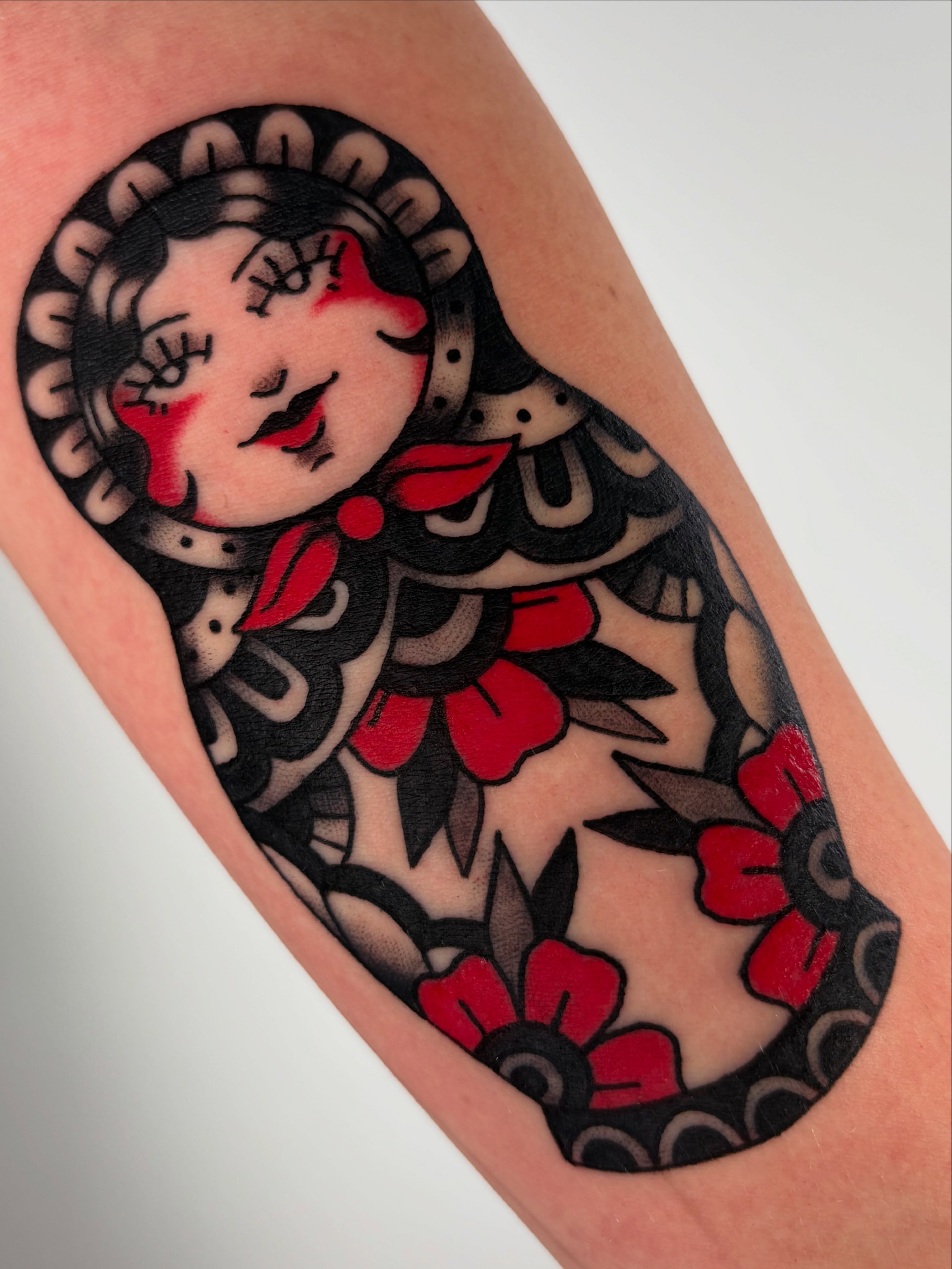 Matryoshka doll American traditional tattoo on the forearm by Lorelei