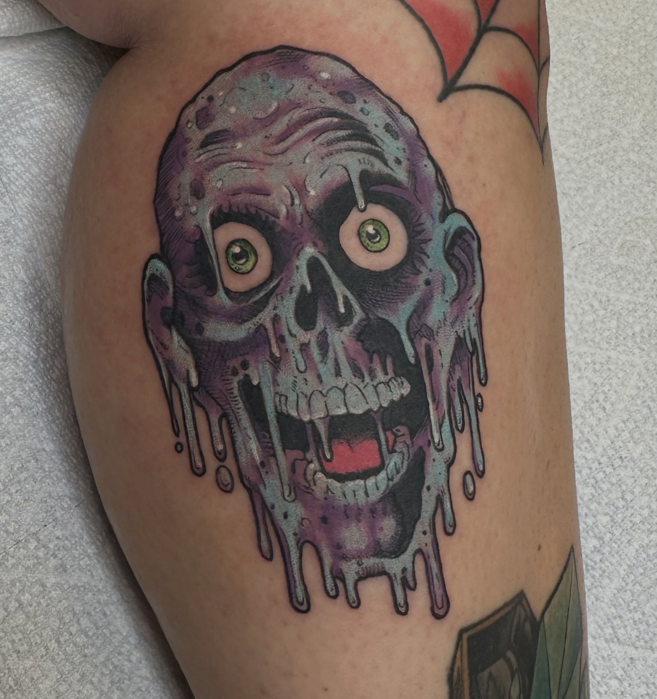 Zombie head dark realism tattoo on the thigh by Jenn Golgan