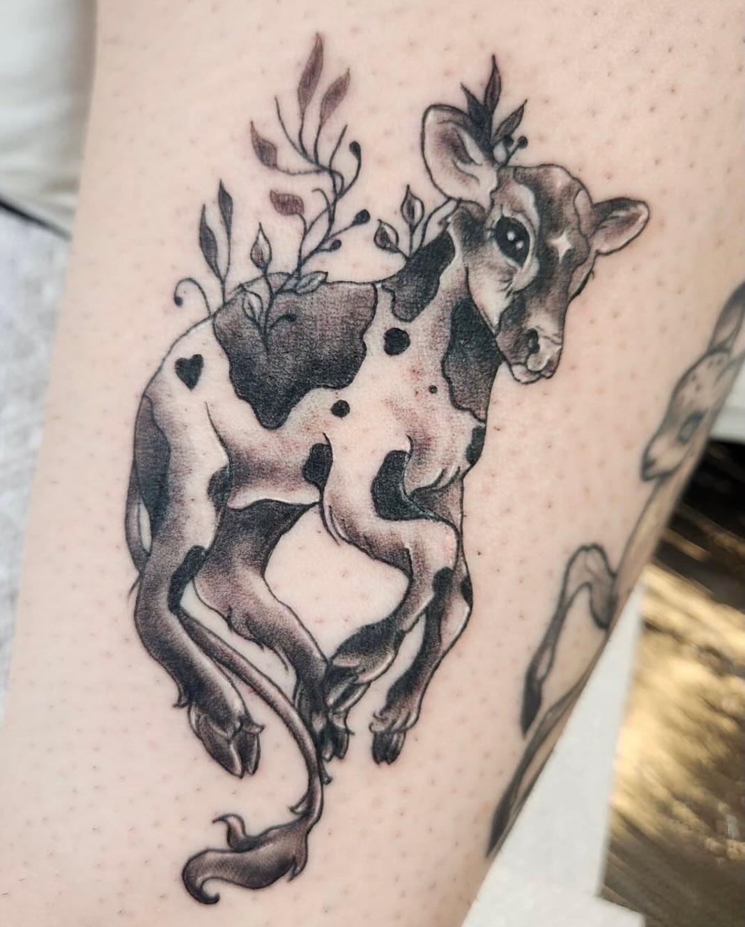 Cow with floral horns realism tattoo on the thigh by Heather
