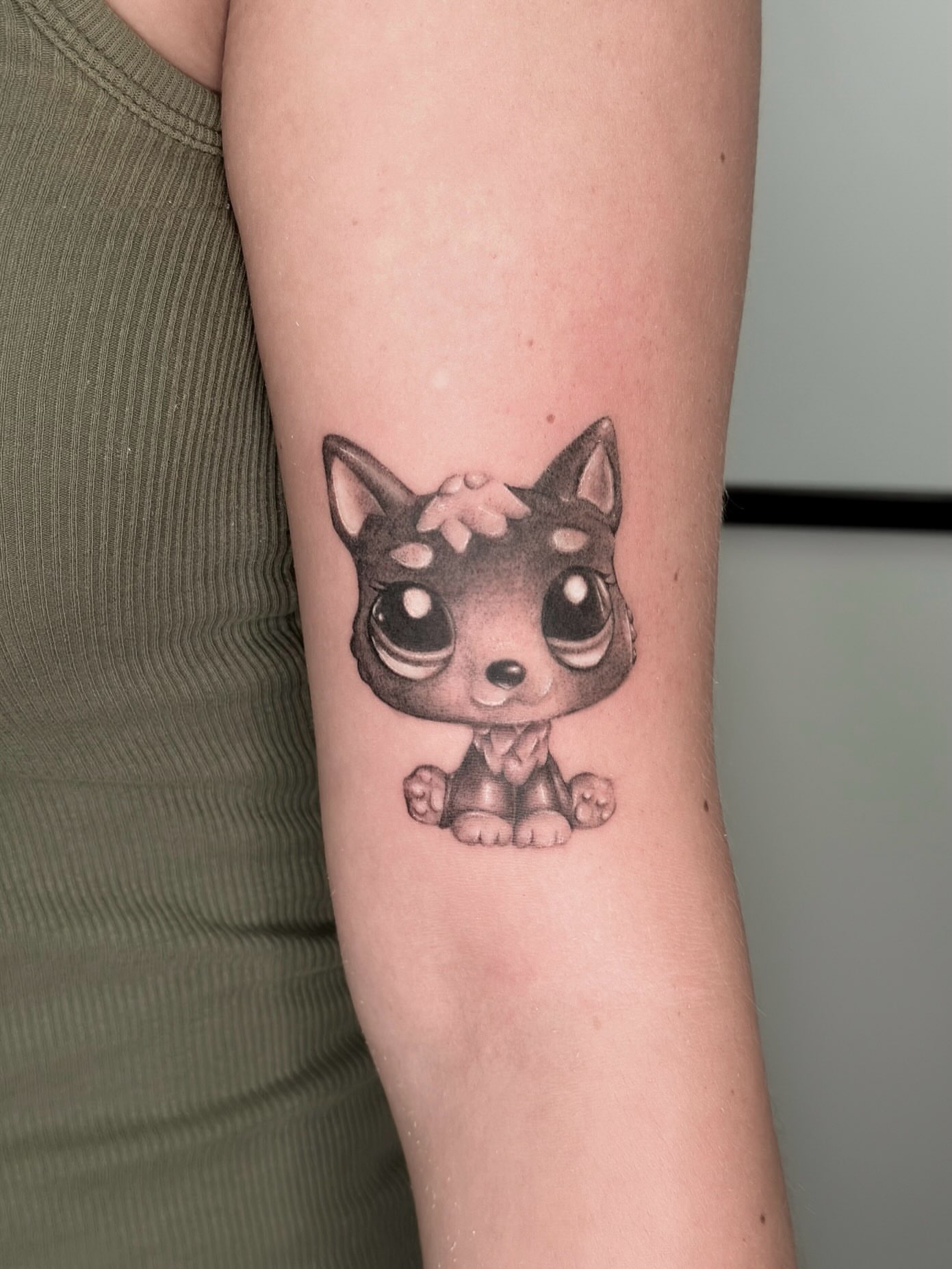 Chibi dog dotwork tattoo on the forearm by kenna