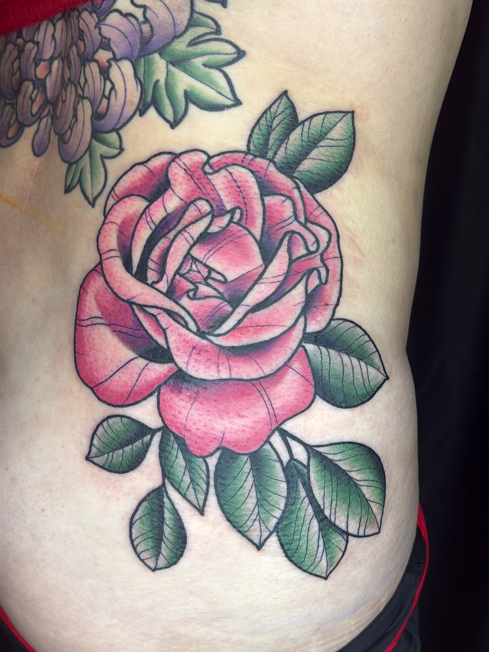Rose American traditional tattoo on the ribs by Kimber Teatro, Portland, Oregon