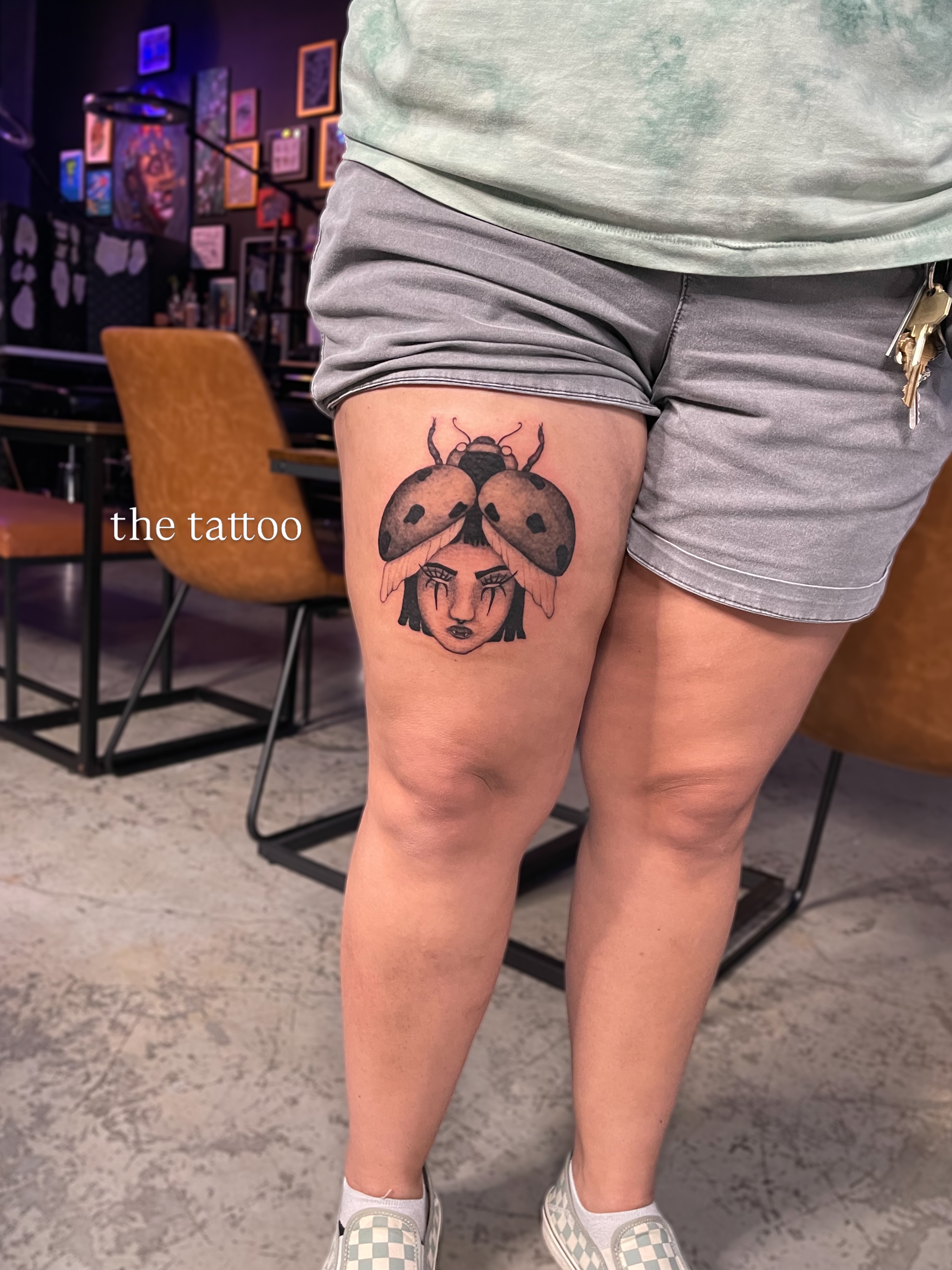 Ladybug and woman realism tattoo on the thigh by Amy