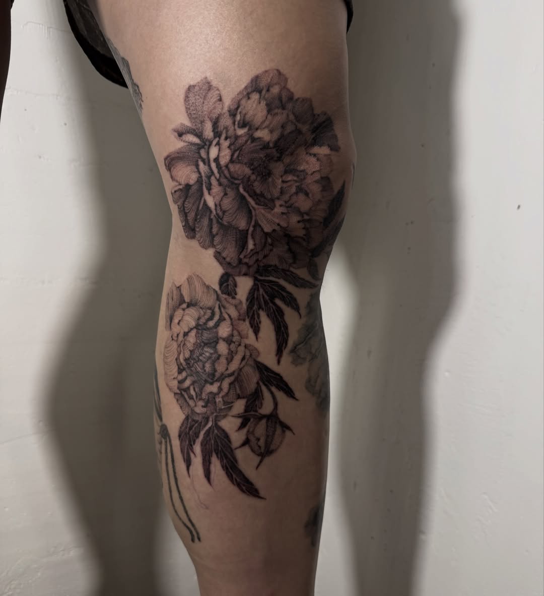 Peony flowers black and grey tattoo on the forearm by Tianna Osborne