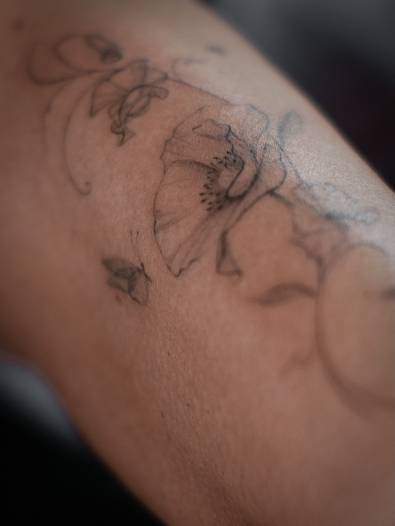 Flower black and grey tattoo on the forearm by Aries Rising