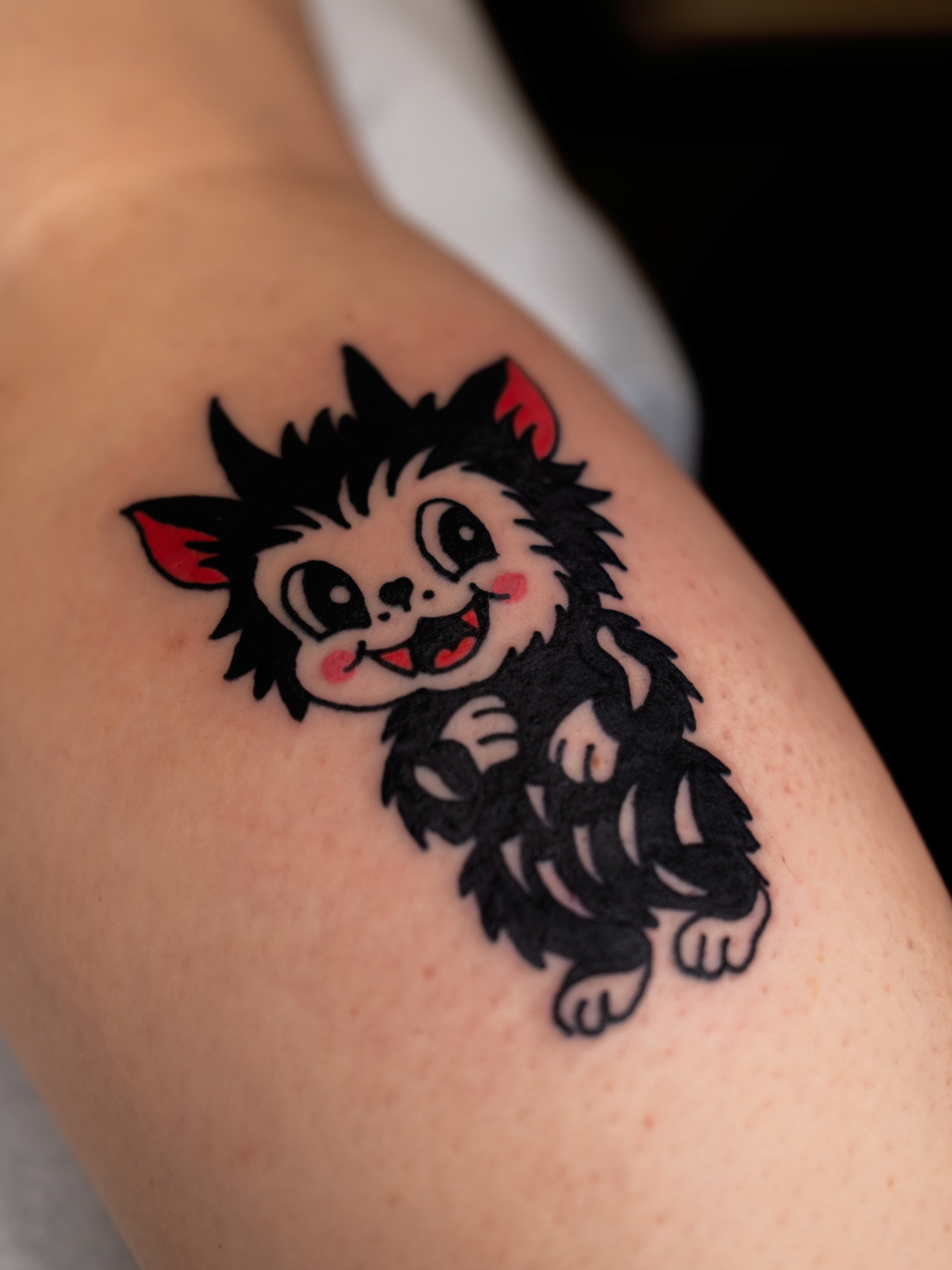 Kitty black and grey tattoo on the shoulder by Neto Velasco - Sad Cat Tattoo, Austin, Texas