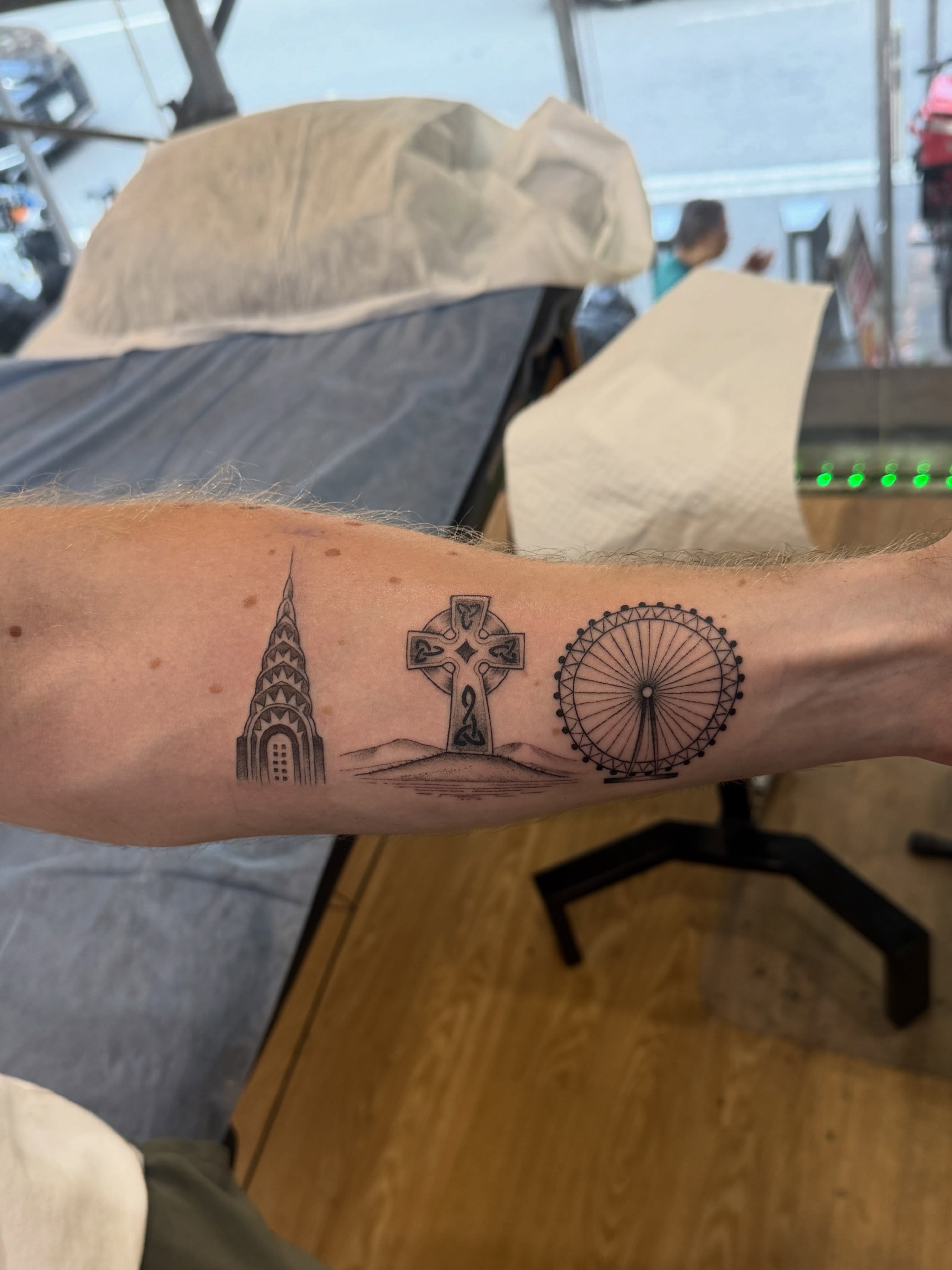 Landmarks black and grey tattoo on the forearm by Matt Kearney